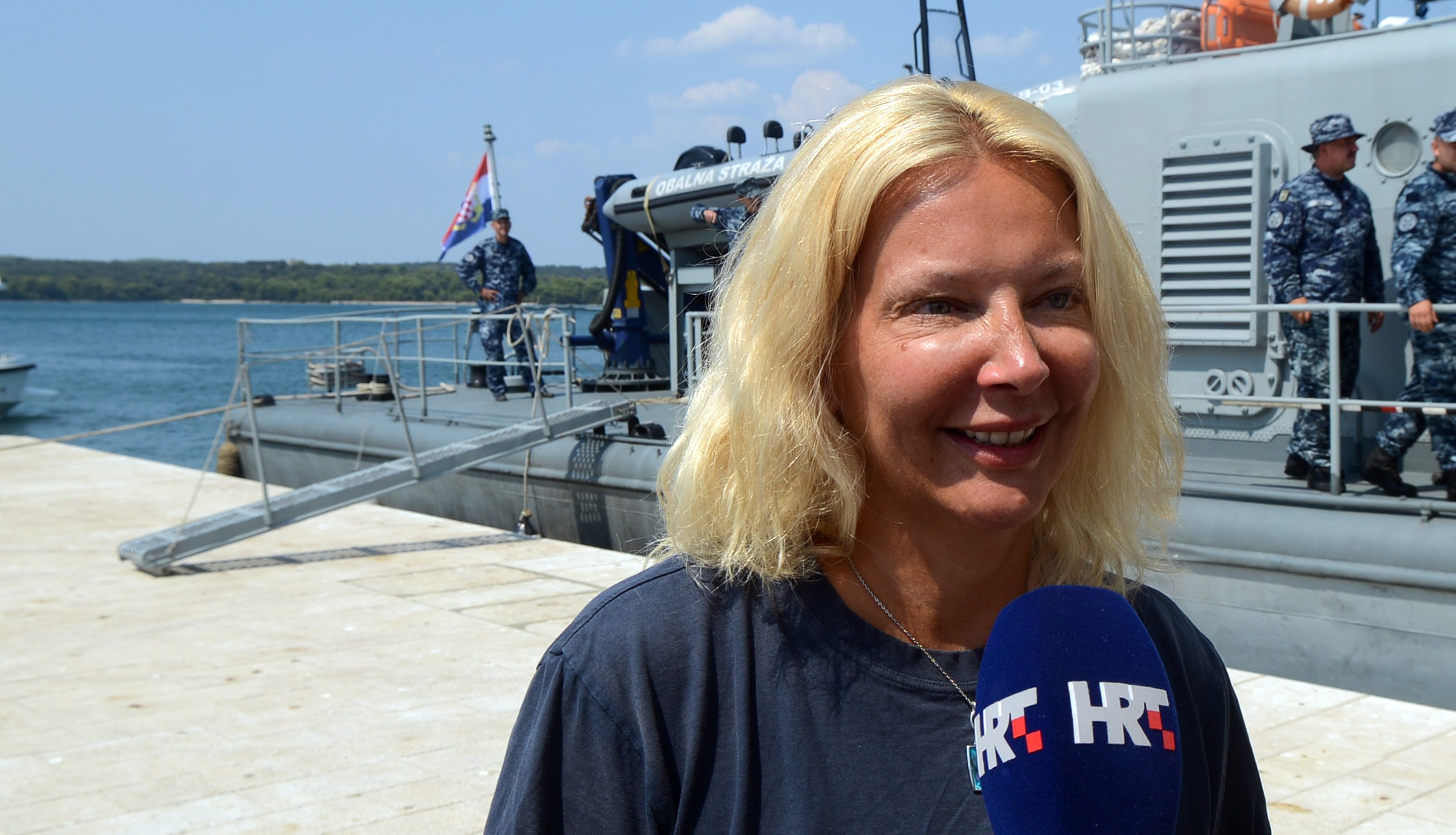 British tourist Kay Longstaff speaks to the press upon her arrival in Pula with the Croatias coast guard ship, on August 19, 2018, which saved her after falling off a cruise ship near Croatian coast. (Credit: STR/AFP/Getty Images).