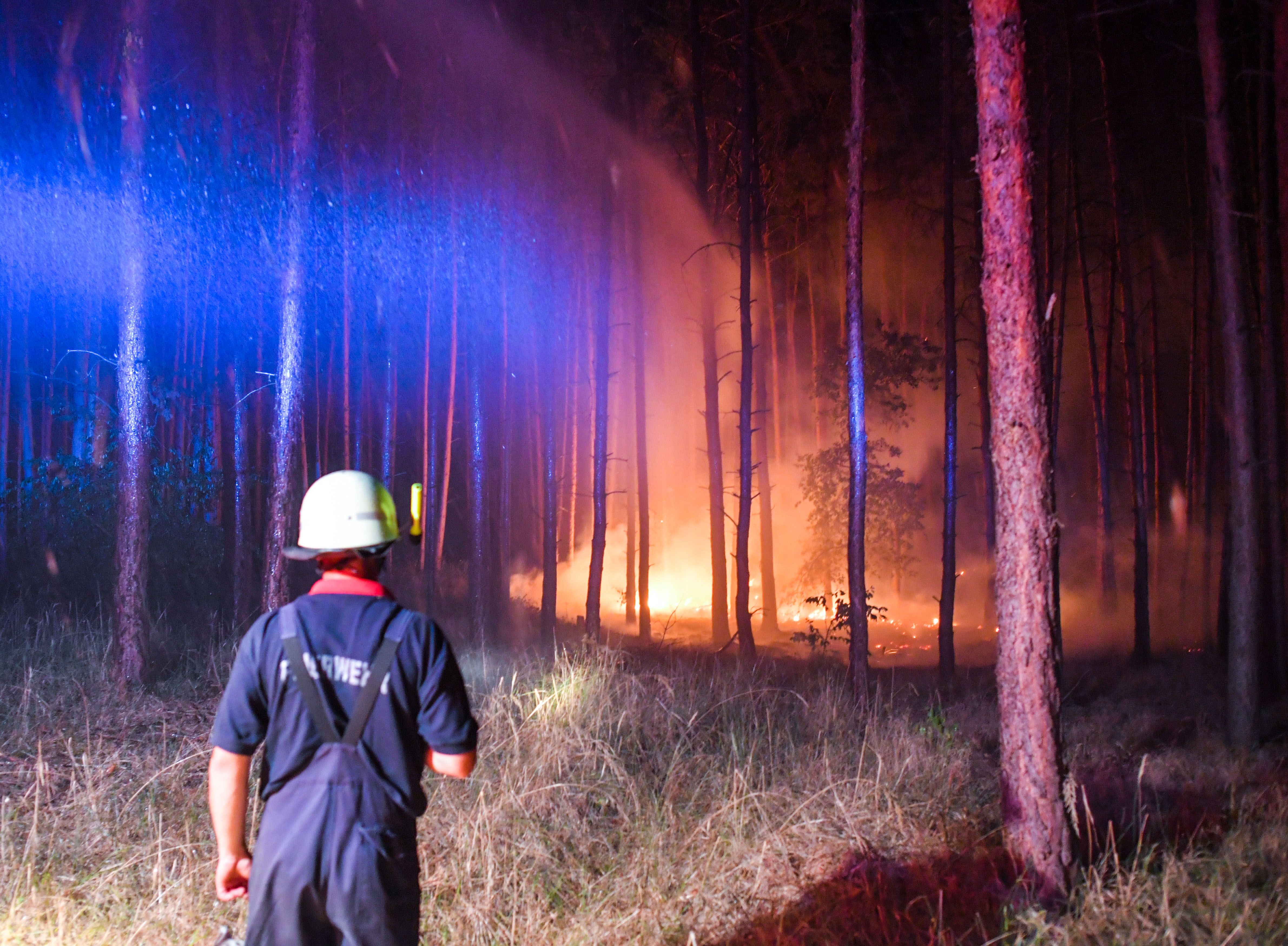 Firefighters work to put out a blaze in Klausdorf, northeastern Germany on Aug. 24, 2018. (Credit: Patrick Pleul/AFP/Getty Images)