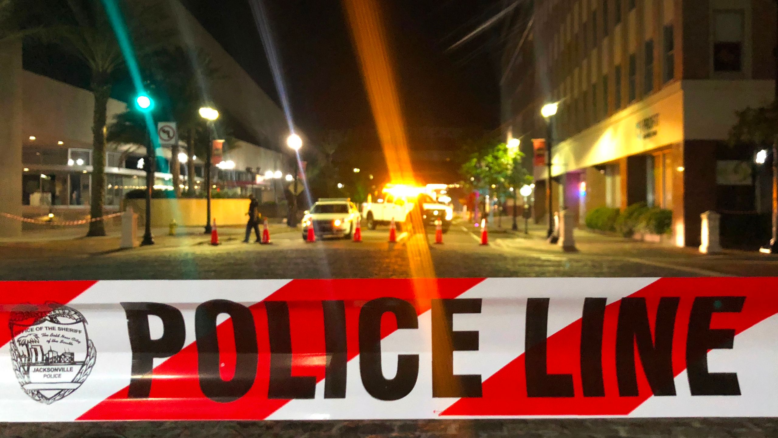 A patrol car is seen behind police tape blocking a street leading to the Jacksonville Landing area in downtown Jacksonville, Florida, on Aug. 26, 2018. (Credit: GIANRIGO MARLETTA/AFP/Getty Images)