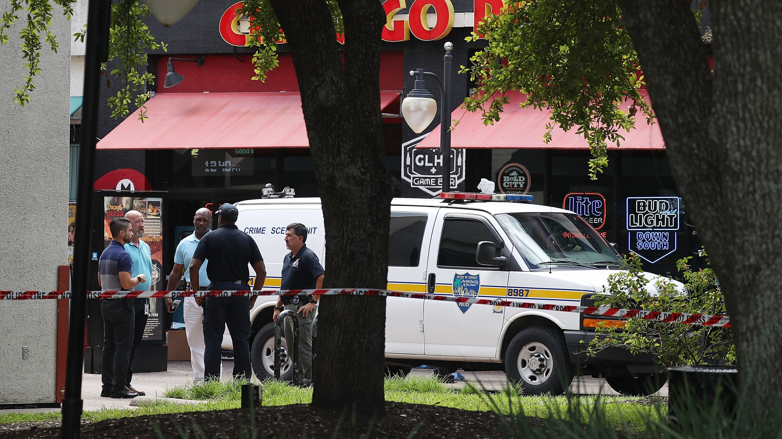 Law enforcement officials investigate a shooting in the GLHF Game Bar where 3 people including the gunman were killed at the on Aug. 27, 2018 in Jacksonville. (Credit: Joe Raedle/Getty Images)