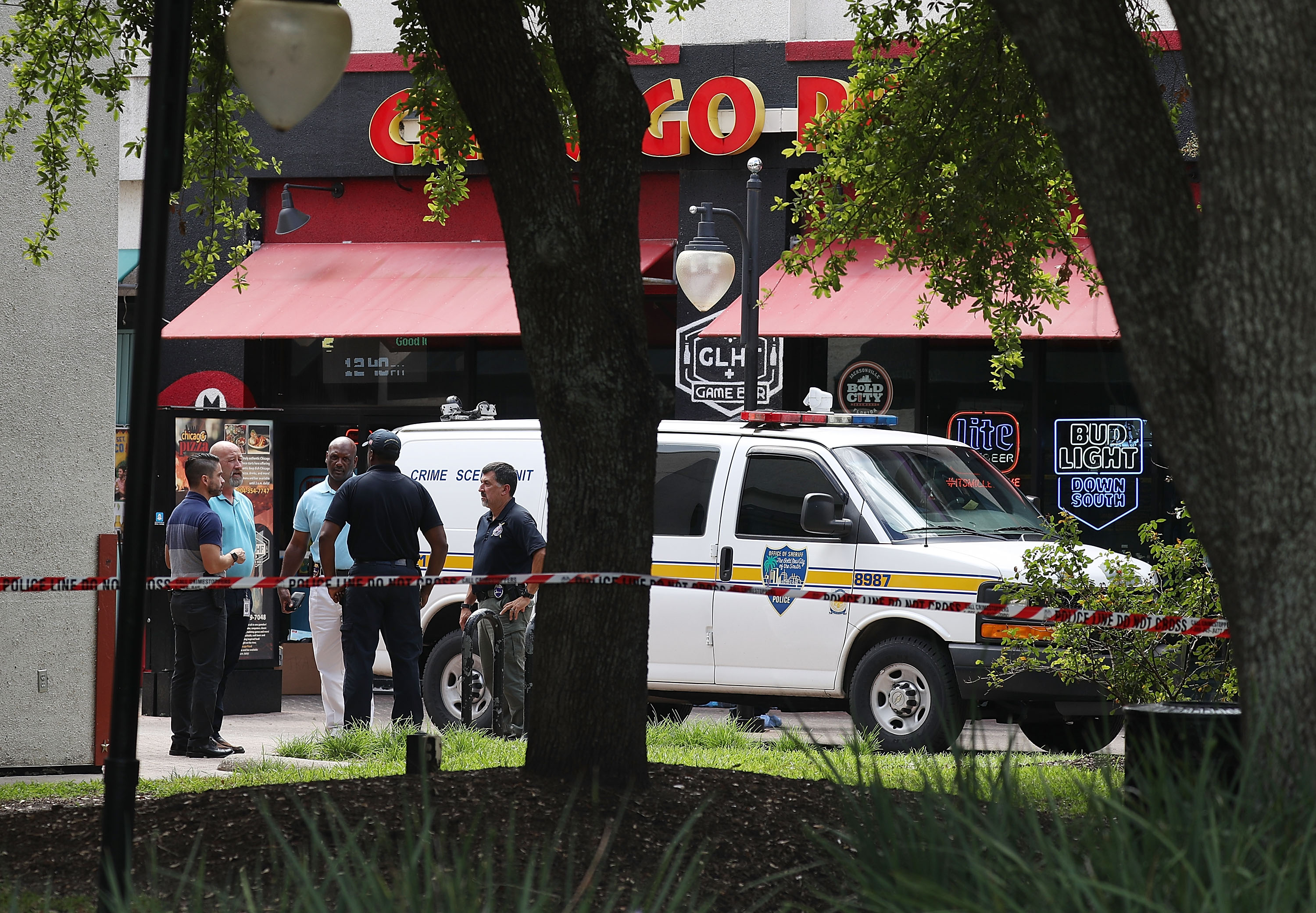 Law enforcement officials investigate a shooting in the GLHF Game Bar where 3 people including the gunman were killed at the on Aug. 27, 2018 in Jacksonville. (Credit: Joe Raedle/Getty Images)