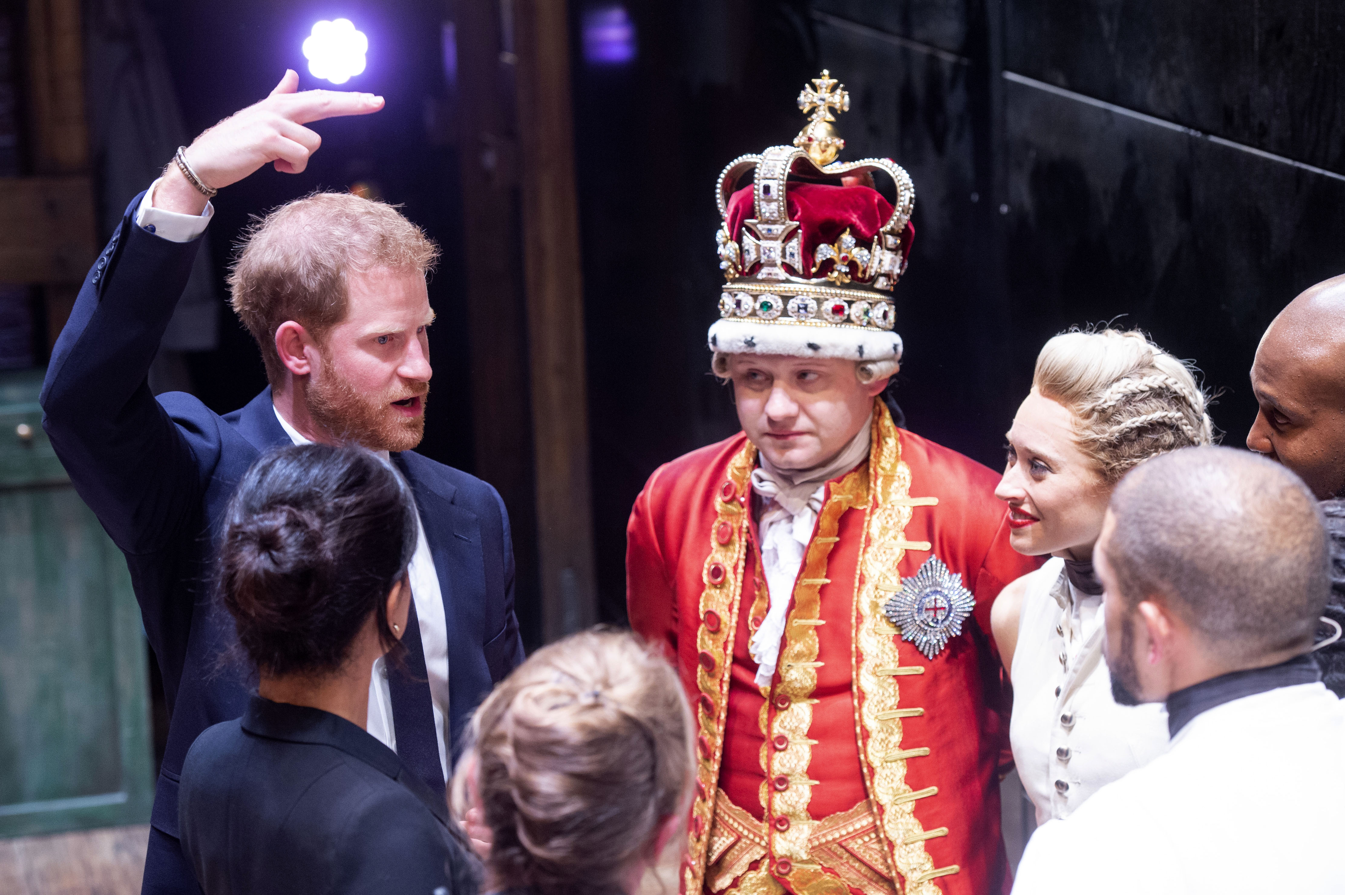 Meghan, Duchess of Sussex (L) and Prince Harry, Duke of Sussex meet the cast and crew of 'Hamilton' backstage after the gala performance in support of Sentebale at Victoria Palace Theatre on August 29, 2018 in London, England. (Credit: WPA Pool/Getty Images)