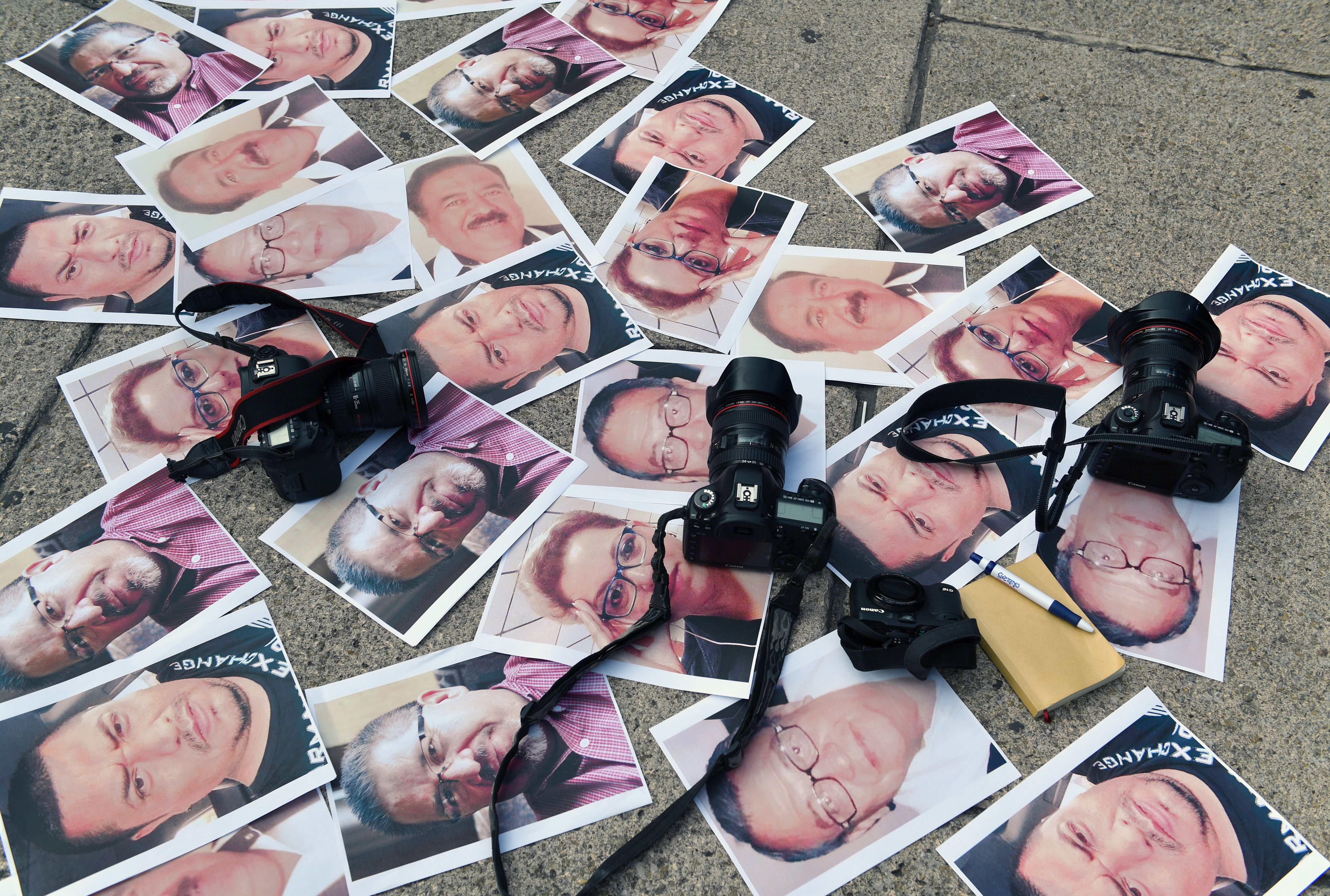 Cameras and pictures of journalists recently murdered in different Mexican states are placed at Independence Angel square in Mexico City during a protest on May 16, 2017. (Credit: Yuri Cortez / AFP / Getty Images)