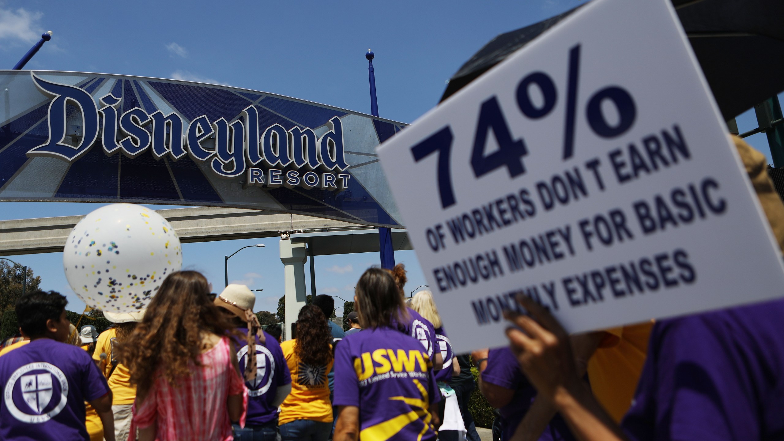 Protestors march at the Disneyland entrance on July 3, 2018 in Anaheim. (Credit: Mario Tama/Getty Images)