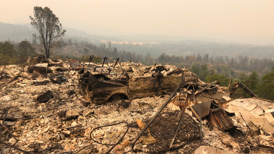 Rubble is seen in an area near Redding on July 29, 2018, after the destructive Carr Fire tore through area. (Credit: GIANRIGO MARLETTA/AFP/Getty Images)