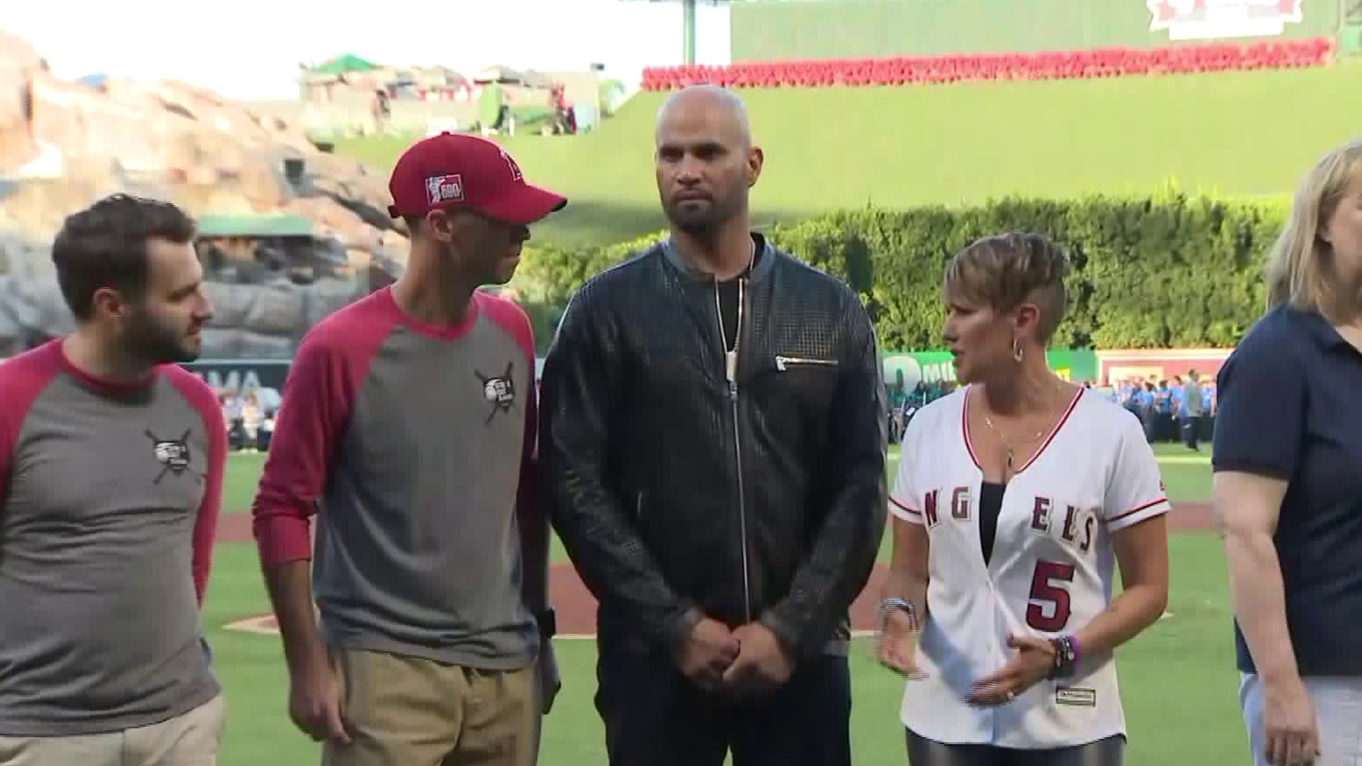 The founders of anti-human trafficking organization "Strike Out Slavery," Los Angeles Angels Baseman Albert Pujols and his wife, Deidre, stand alongside other organizers during an event in Anaheim on Sept. 15, 2018. (Credit: KTLA)