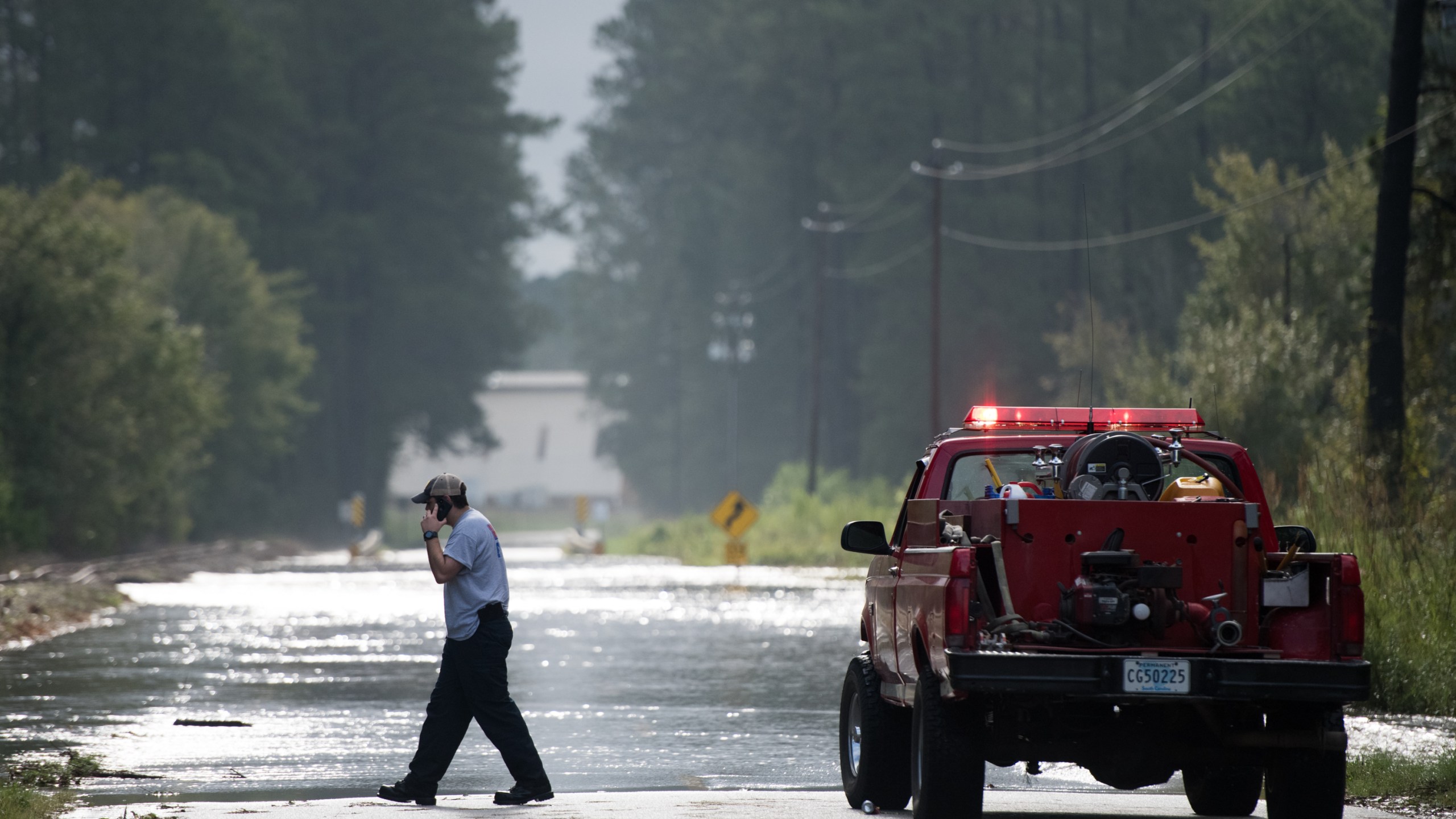 Wallace firefighter A.J. Jackson explores a flooded road after Hurricane Florence struck the Carolinas September 17, 2018, in Wallace, South Carolina. (Credit: Sean Rayford/Getty Images)