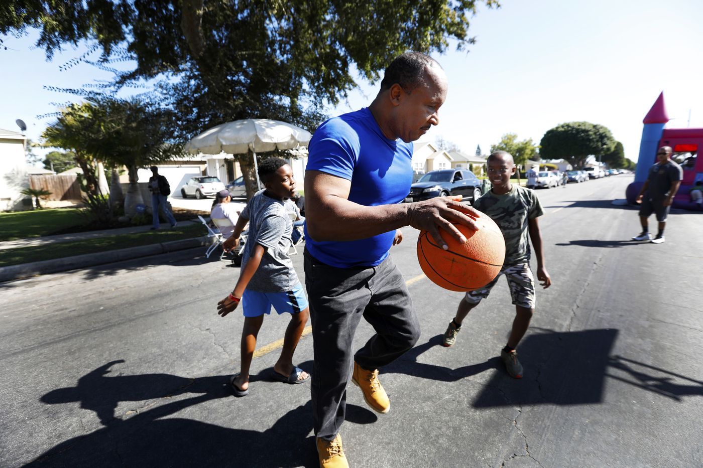 Inglewood Mayor James T. Butts Jr. plays basketball with boys while attending a block club party in September, 2018.(Credit: Francine Orr / Los Angeles Times)