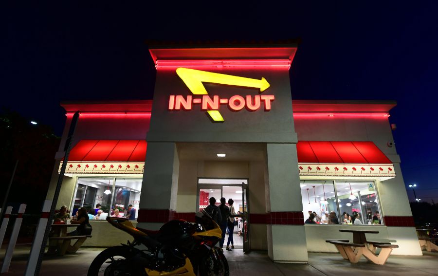 People enter an In-N-Out Burger in Alhambra on Aug. 30, 2018. (Credit: Frederic J. Brown / AFP / Getty Images)