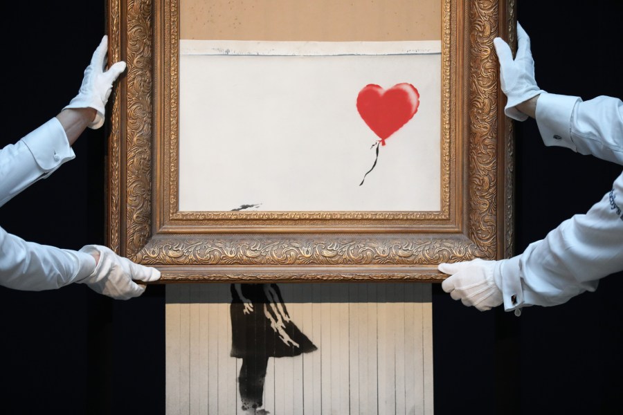 Sotheby’s unveils Banksy’s newly-titled "Love is in the Bin" at Sotheby's in London on Oct. 12, 2018. Originally titled "Girl with Balloon," the canvas passed through a hidden shredder seconds after the hammer fell at Sotheby’s London Contemporary Art Evening Sale on Oct. 5, 2018, making it the first artwork in history to have been created live during an auction. (Credit: Tristan Fewings / Getty Images for Sotheby's)