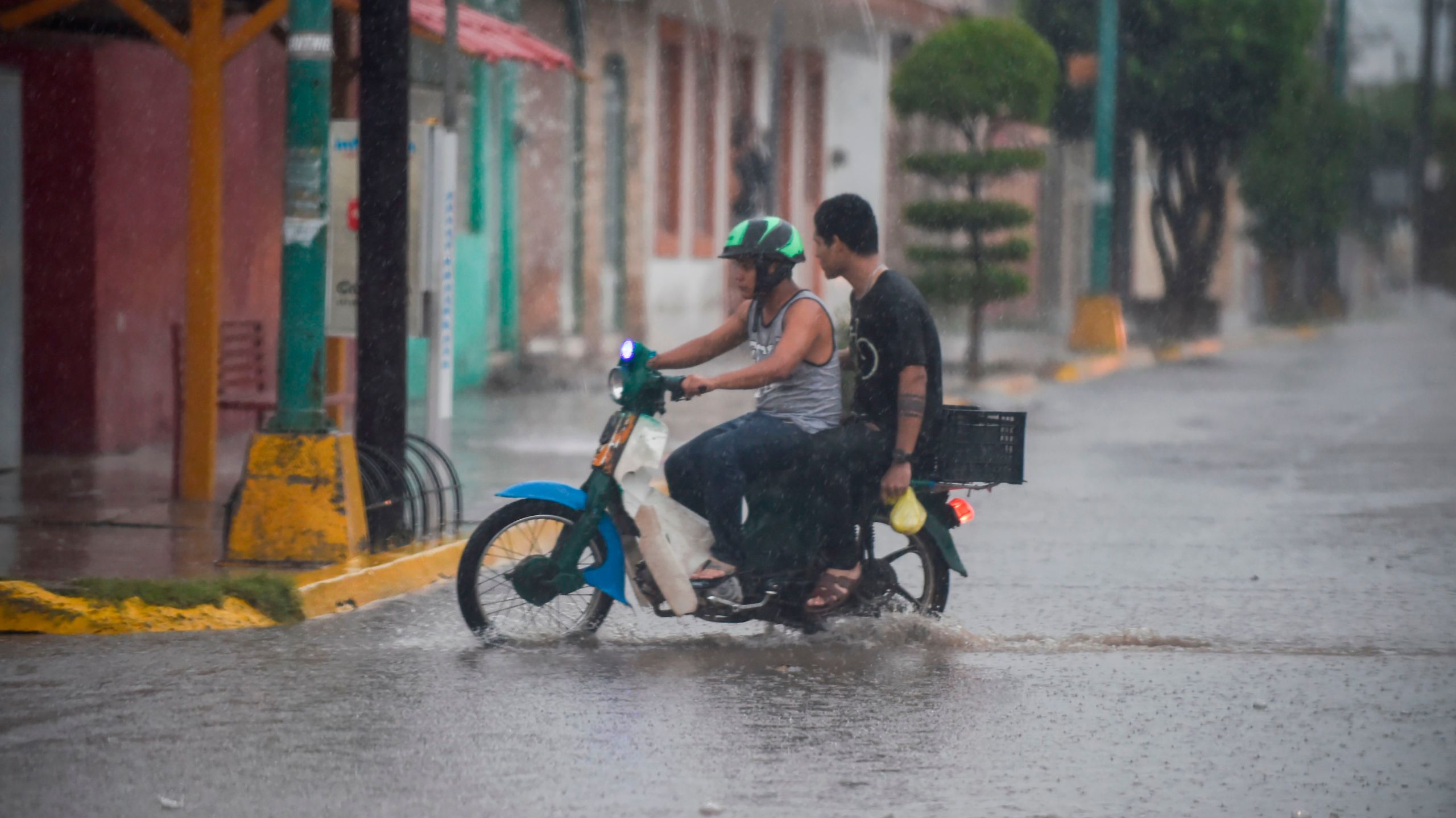 Resident rides their motorcycle as the Hurricane Willa arrives to Escuinapa, Sinaloa state, Mexico, on Oct. 23, 2018. (Credit: Alfredo Estrella / AFP / Getty Images)