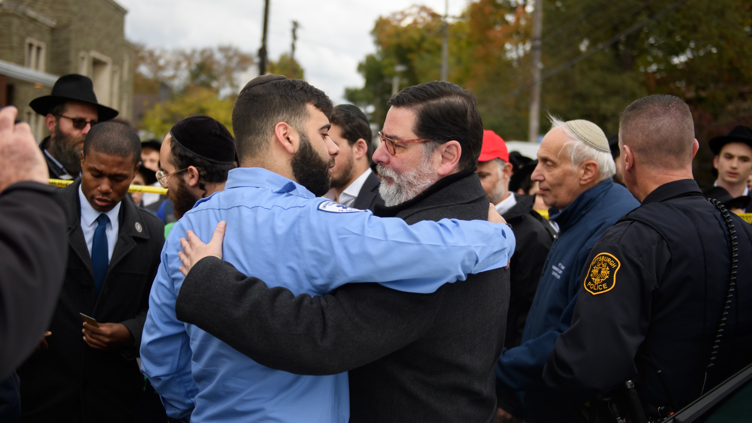 Pittsburgh Mayor Bill Peduto hugs an EMT after a prayer held at the site of the mass shooting that killed 11 people on Oct. 29, 2018. (Credit: Jeff Swensen/Getty Images)