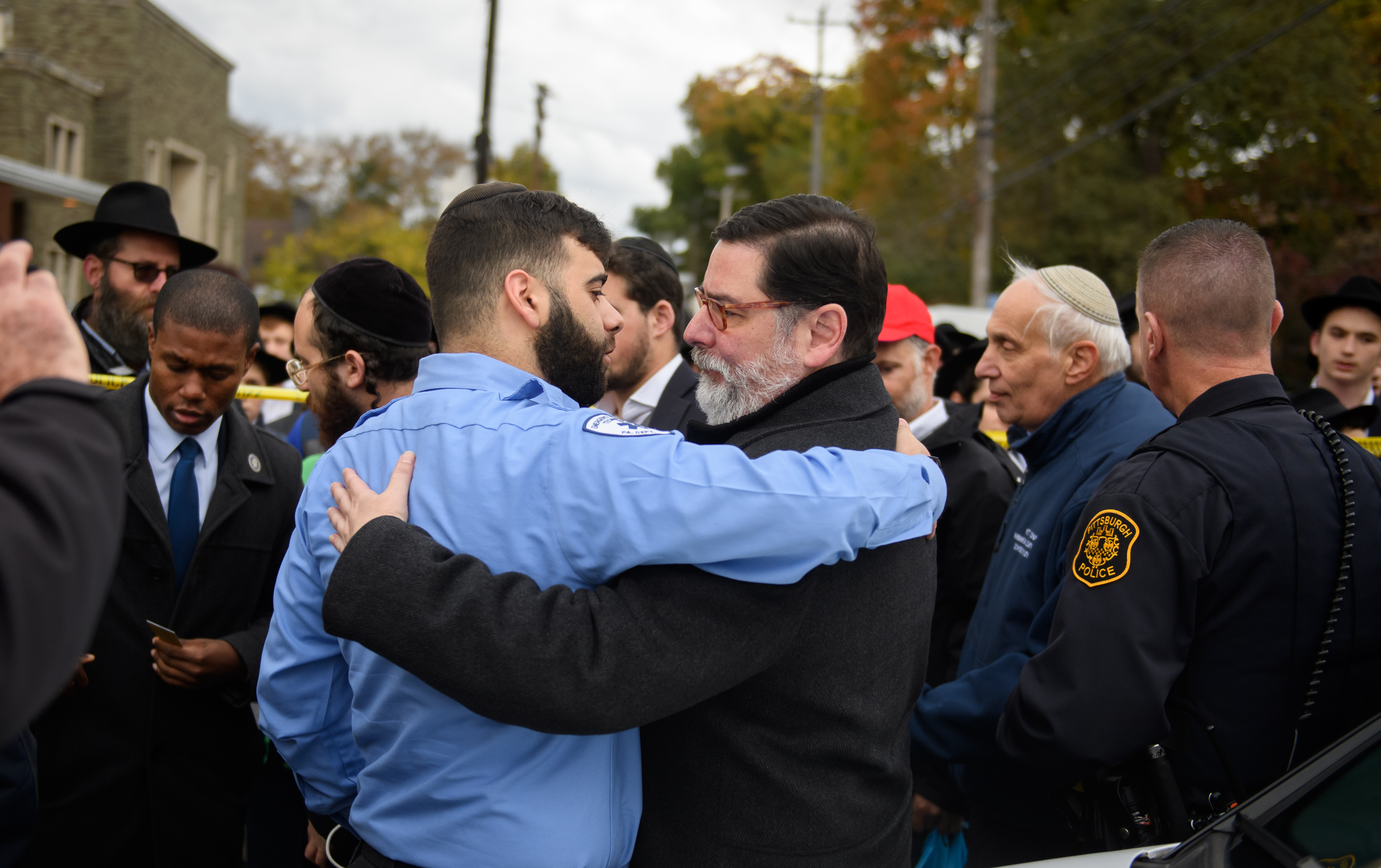 Pittsburgh Mayor Bill Peduto hugs an EMT after a prayer held at the site of the mass shooting that killed 11 people on Oct. 29, 2018. (Credit: Jeff Swensen/Getty Images)