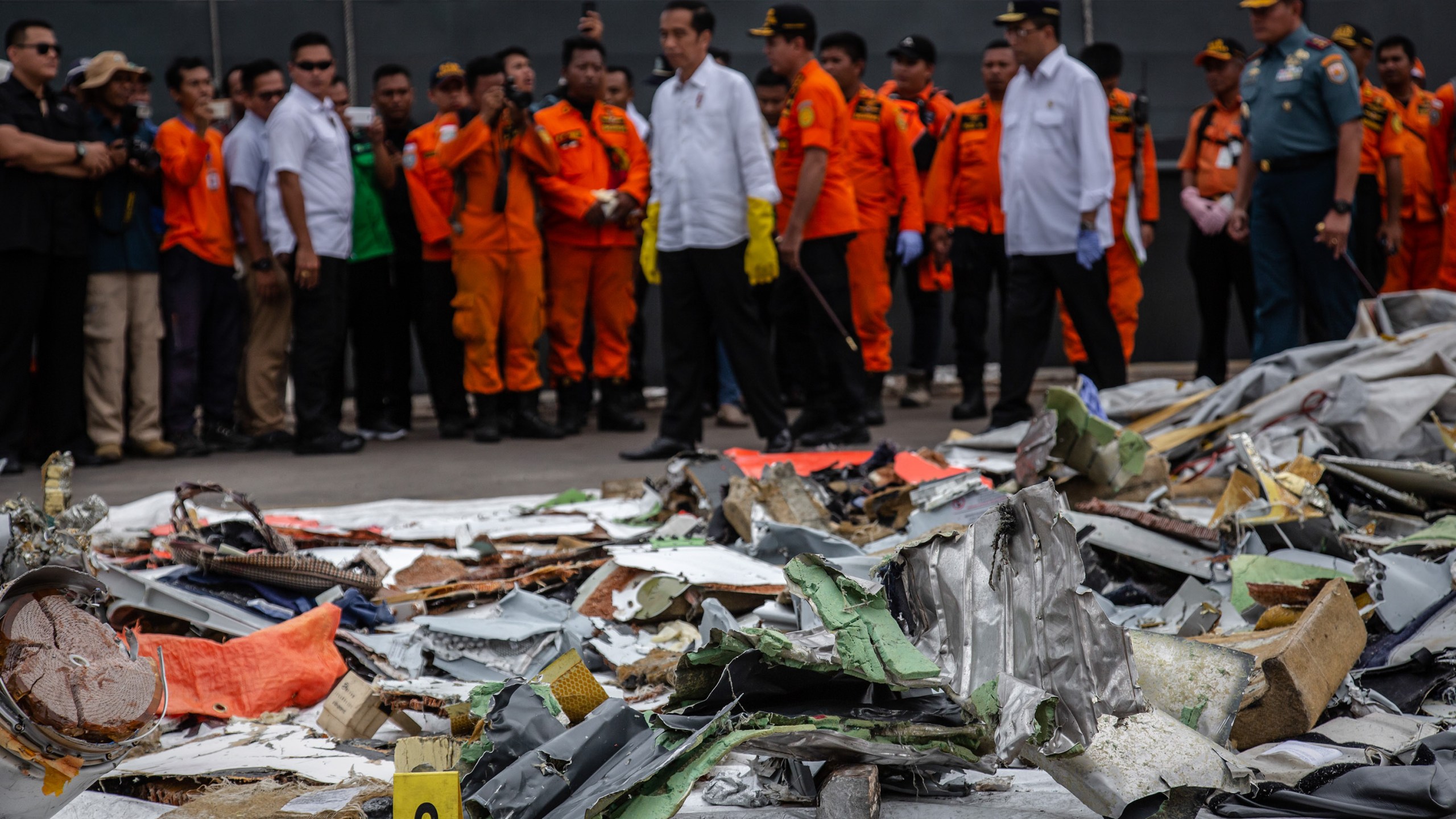 Indonesia's President Joko Widodo (center), inspects recovered debris and personal items from Lion Air flight JT 610 at the Tanjung Priok port on Oct. 30, 2018. (Credit: Ulet Ifansasti/Getty Images)