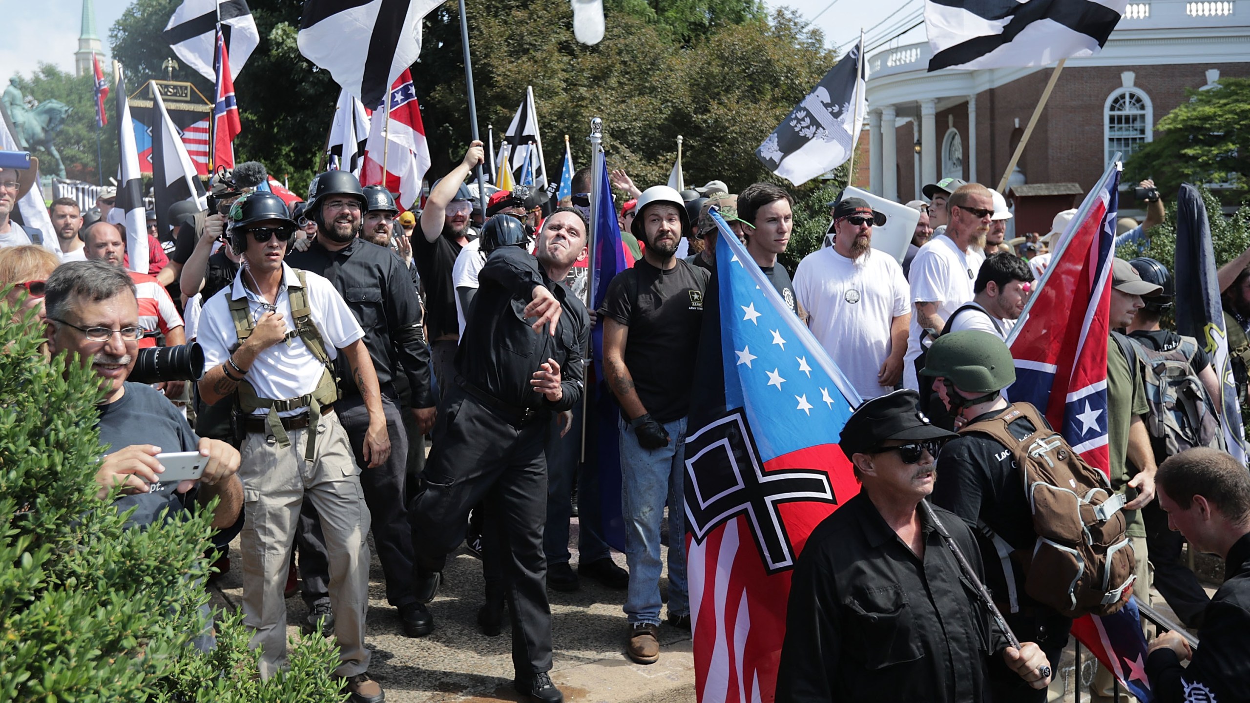 Hundreds of white nationalists, neo-Nazis, KKK and members of the "alt-right" hurl water bottles back and forth against counter demonstrators on the outskirts of Emancipation Park during the Unite the Right rally Aug. 12, 2017 in Charlottesville, Virginia. (Credit: Chip Somodevilla/Getty Images)