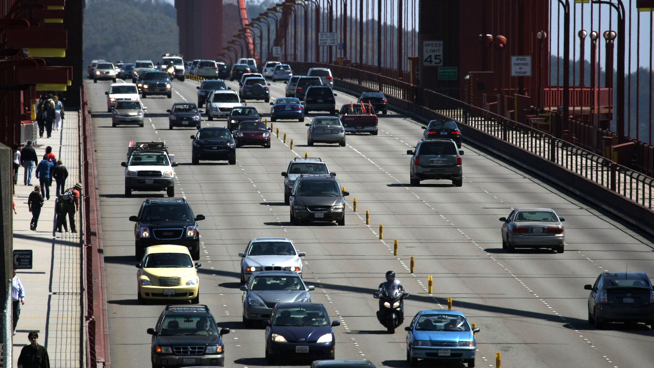 Cars drive across the Golden Gate Bridge May 19, 2009, in San Francisco. At the time, President Obama had announced a new national fuel and emission standards program for cars and trucks with the intention of cutting vehicle carbon emissions and raising mileage by 30 percent. (Credit: Justin Sullivan/Getty Images)