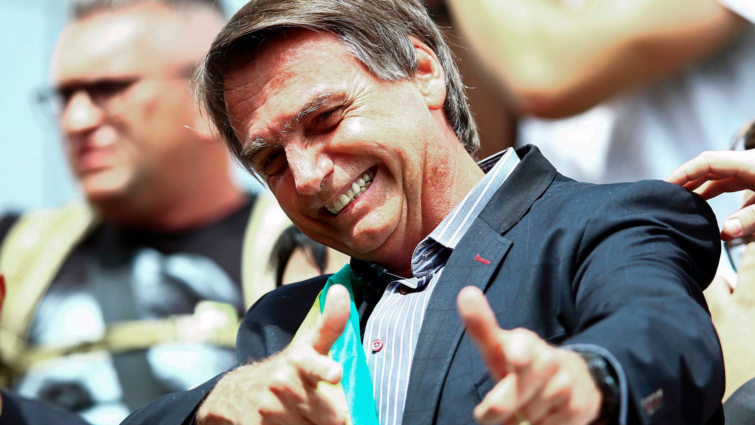 Jair Bolsonaro gives a thumbs up to supporters during a rally at Afonso Pena airport in Curitiba, Brazil on March 28, 2018. (Credit: HEULER ANDREY/AFP/Getty Images)