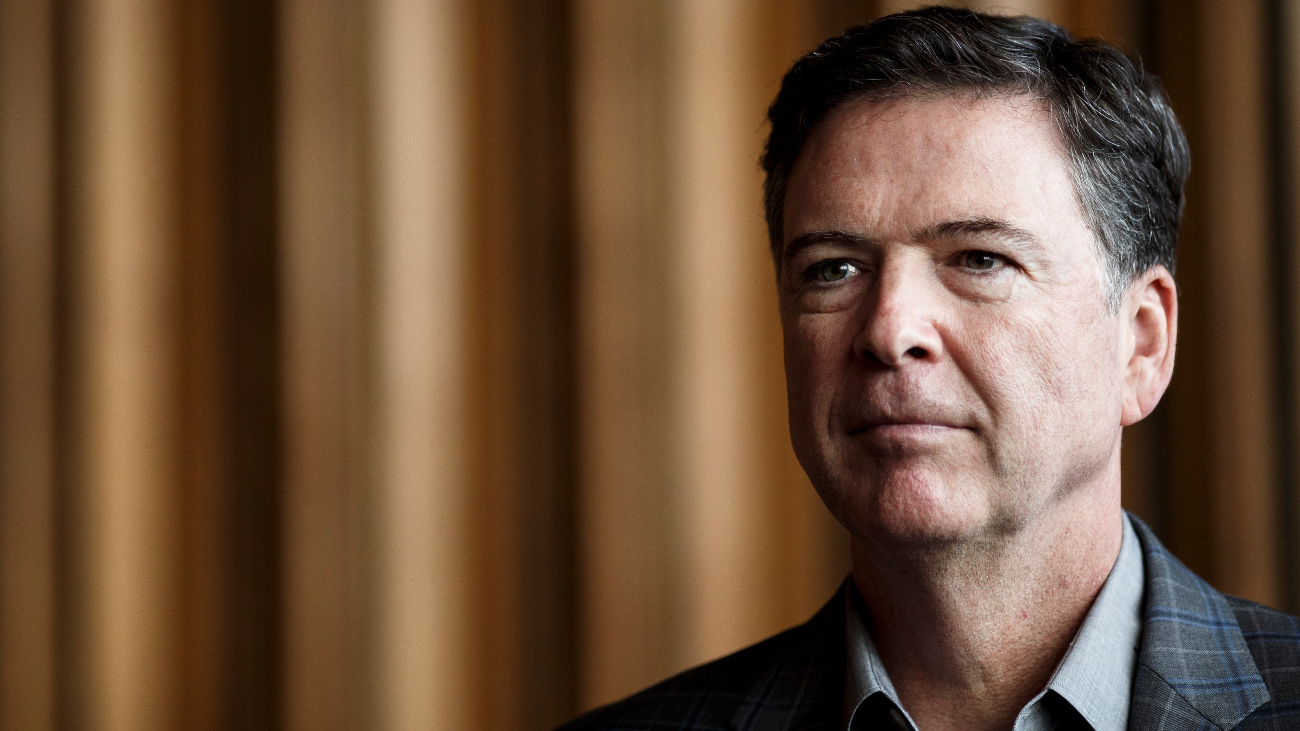 Former FBI Director James Comey talks backstage before a panel discussion about his book on June 19, 2018 in Berlin, Germany. (Credit: Carsten Koall/Getty Images)