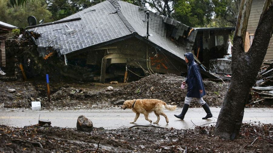 Loreen Zakem walks her dog past one of the homes destroyed in a January debris flow along Montecito Creek in this undated photo. (Credit: Robert Gauthier / Los Angeles Times)