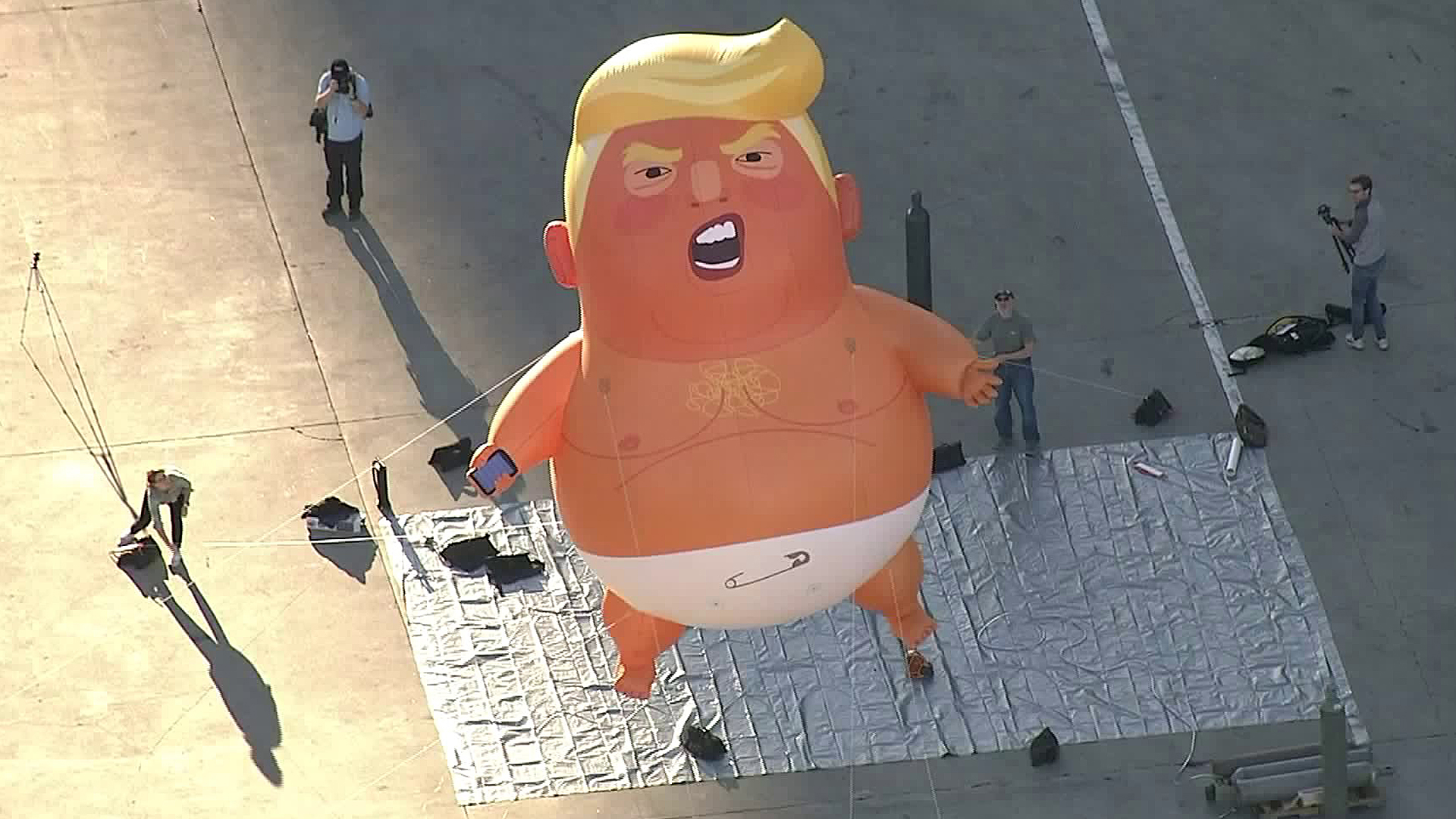 A giant balloon depicting U.S. President Donald Trump as an orange baby is seen in downtown Los Angeles on Oct. 19, 2018. (Credit: KTLA)