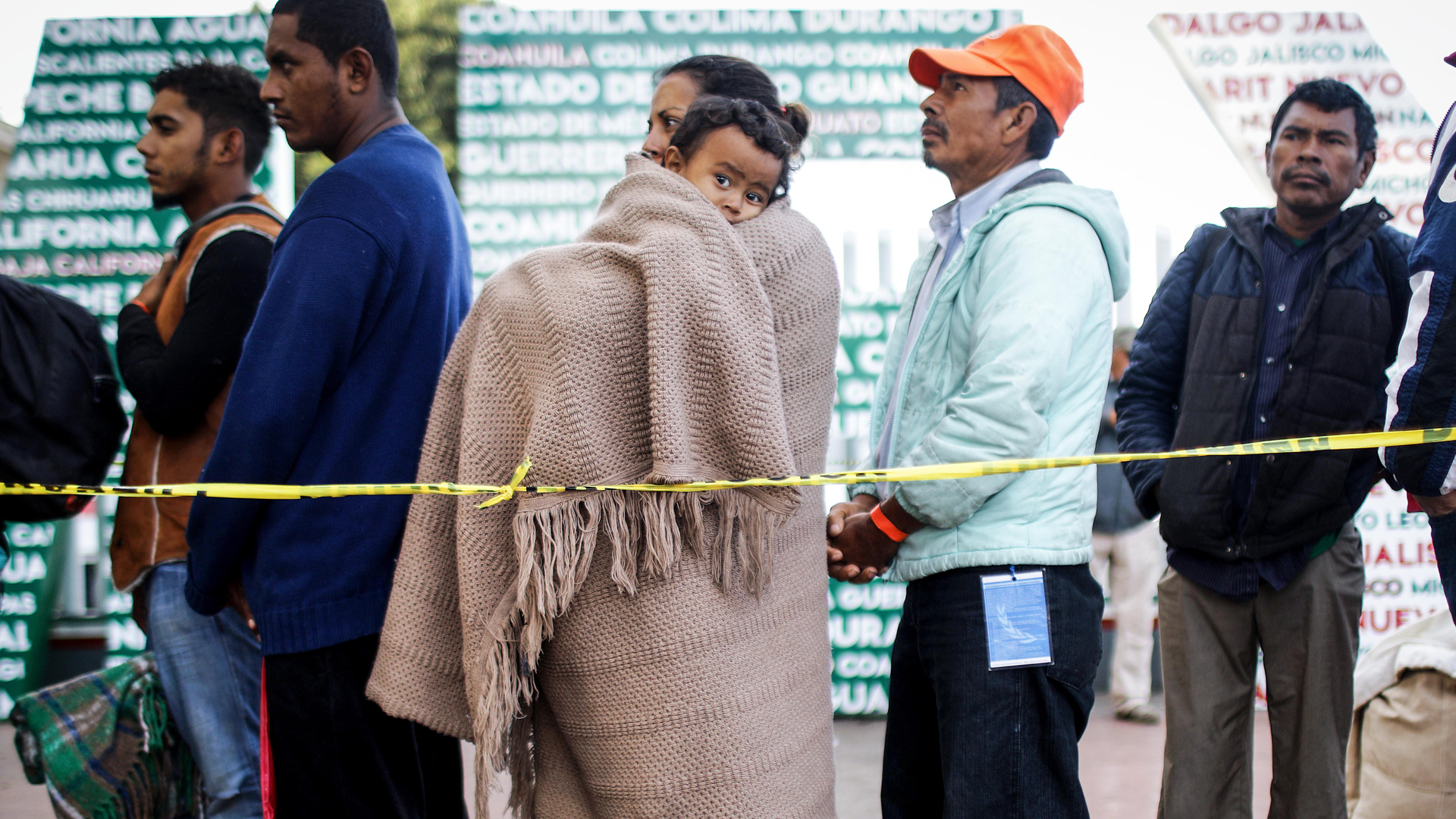 Honduran mother Nubia, center, holds her son Wilmar, 5, as they wait in line for information about applying for asylum in the U.S. on Nov. 23, 2018 in Tijuana, Mexico. (Credit: Mario Tama/Getty Images)