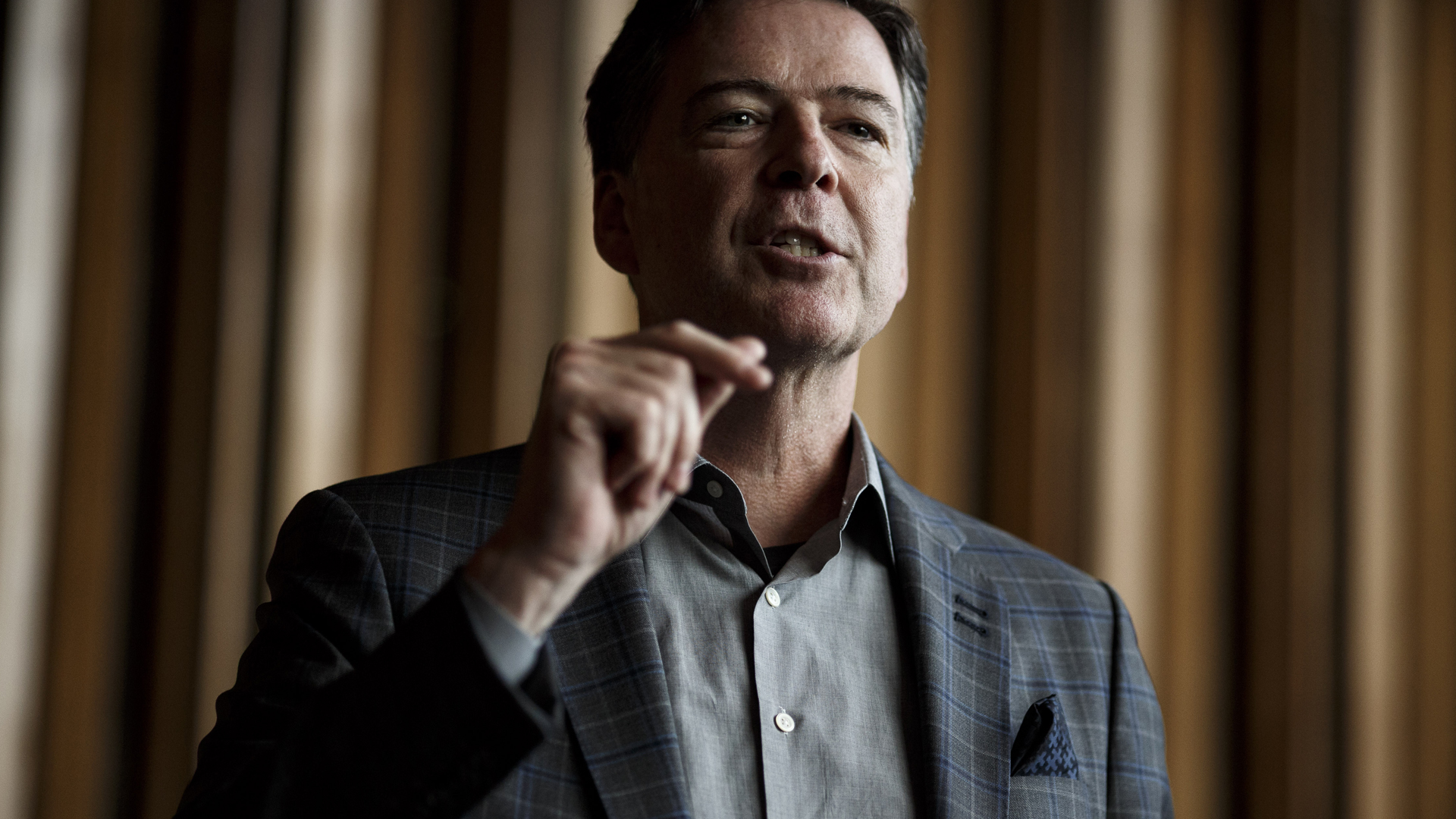 Former FBI Director James Comey talks backstage before a panel discussion about his book "A Higher Loyalty" on June 19, 2018 in Berlin, Germany. (Credit: Carsten Koall/Getty Images)