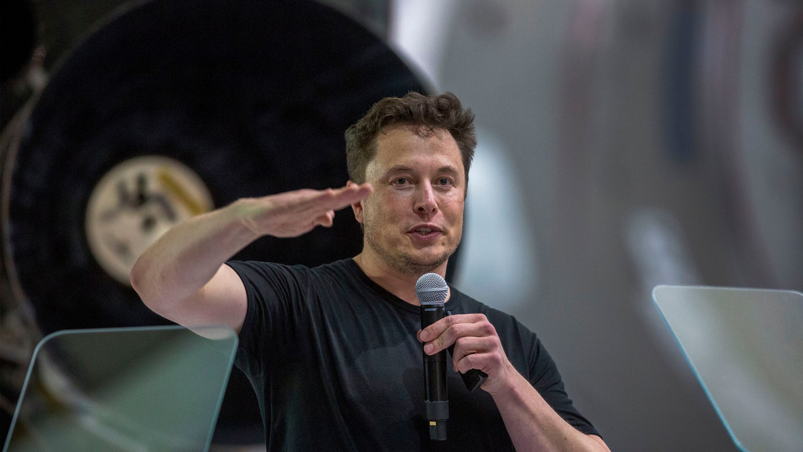 Elon Musk speaks near a Falcon 9 rocket during his announcement that Japanese billionaire Yusaku Maezawa will be SpaceX's first private passenger to fly around the Moon at the company's Hawthorne headquarters on Sept. 17, 2018. (Credit: David McNew / AFP / Getty Images)