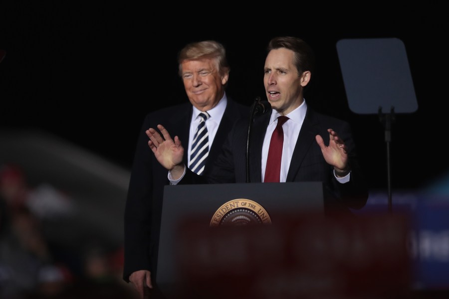 Donald Trump listens as Josh Hawley speaks at a rally on Nov. 1, 2018 in Columbia, Missouri. (Credit: Scott Olson/Getty Images)