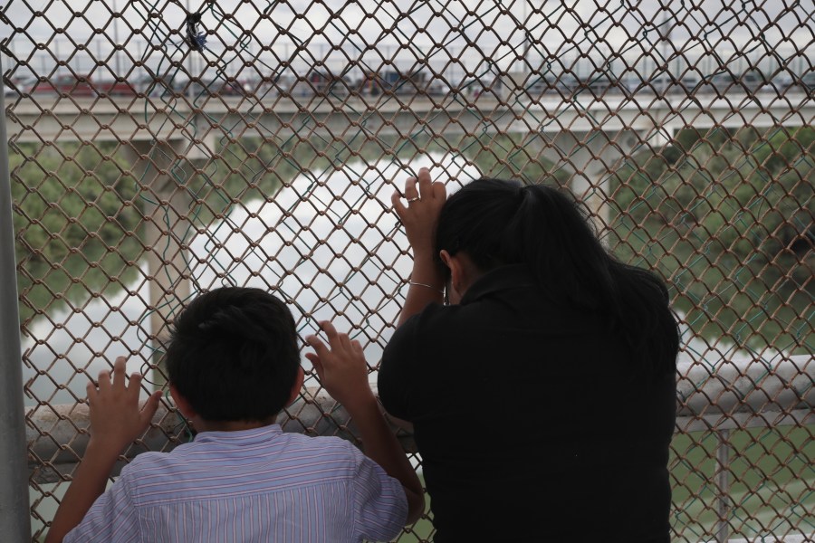 Nicaraguan asylum seekers wait for entry into the United States while on the international bridge on Nov. 4, 2018 in Hidalgo, Texas. (Credit: John Moore/Getty Images)