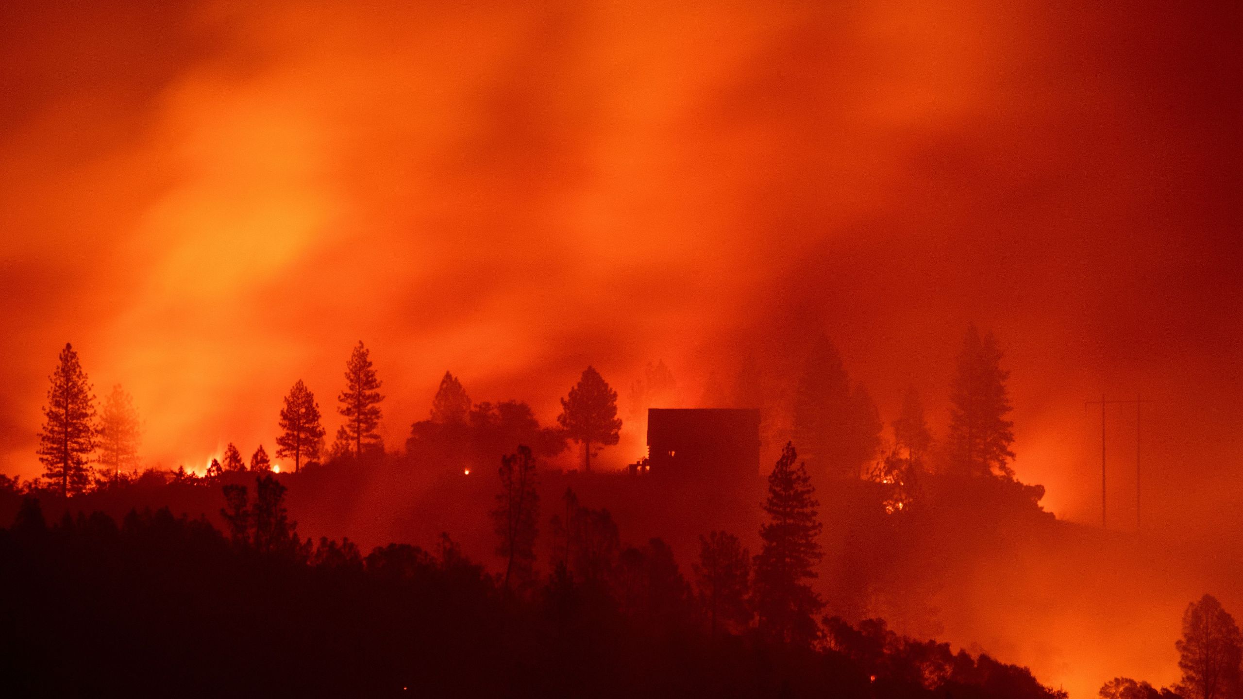 Flames from the Camp Fire burn near a home atop a ridge near Big Bend, California, on Nov. 10, 2018. (Credit: JOSH EDELSON/AFP/Getty Images)