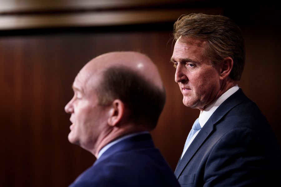 Sen. Jeff Flake (R-AZ), right, and Sen. Christopher A. Coons (D-DE) hold a press conference on legislation to protect the Mueller Investigation on Capitol Hill Nov. 14, 2018. (Credit: BRENDAN SMIALOWSKI/AFP/Getty Images)