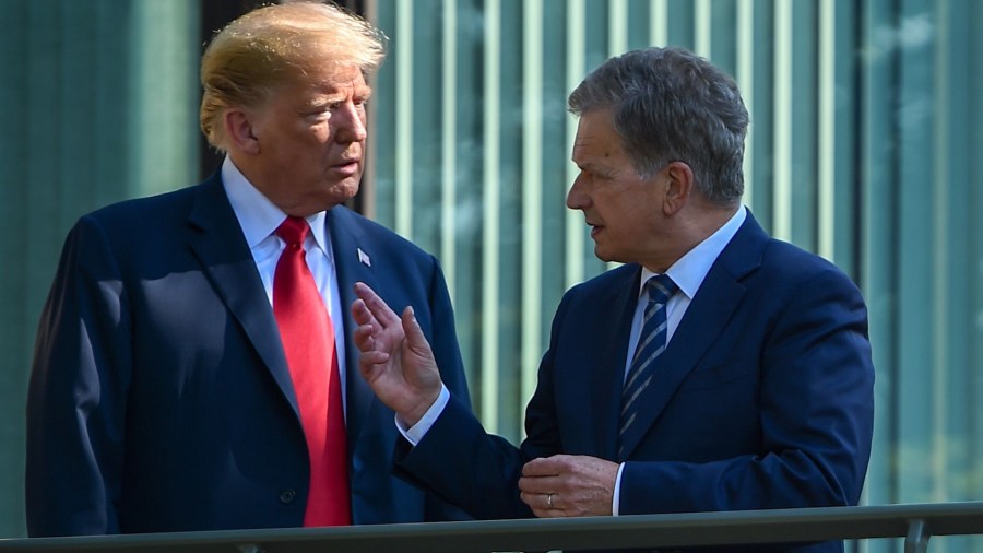 U.S. President Donald Trump and Finnish President Sauli Niinisto talk on the balcony of the Mantyniemi Presidential Residence in Helsinki, on July 16, 2018. (Credit: BRENDAN SMIALOWSKI/AFP/Getty Images)