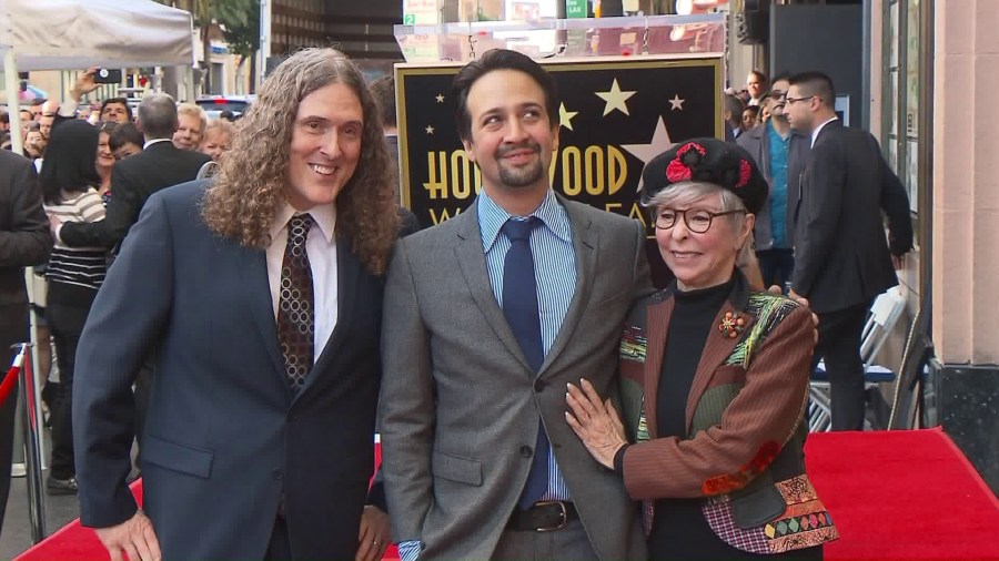 Lin-Manuel Miranda, center, stands alongside Weird Al Yankovic and Rita Moreno while receiving a star on the Hollywood Walk of Fame on Nov. 30, 2018. (Credit: KTLA)