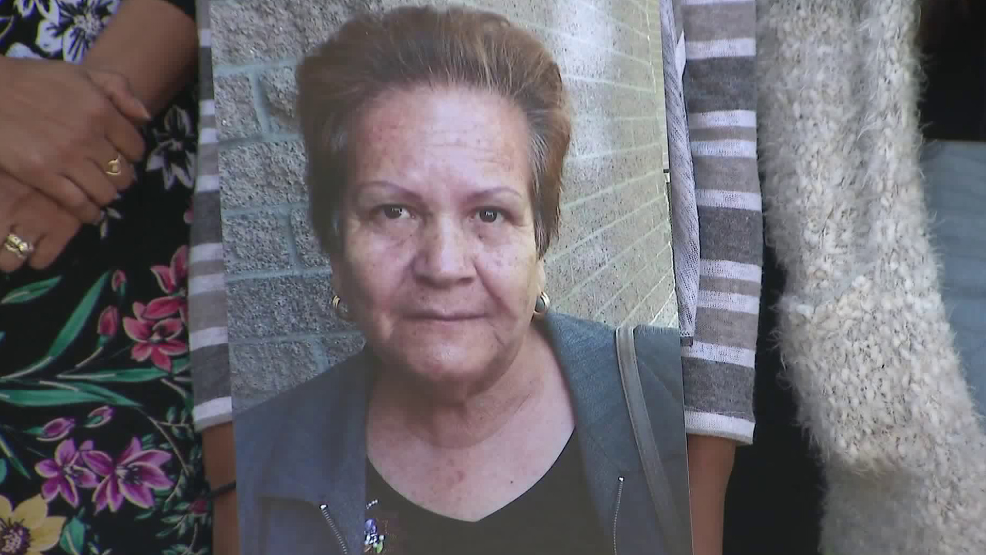 Maria Reynoso's photo is held up by her family at a news conference in South L.A. on Nov. 19. (Credit: KTLA)