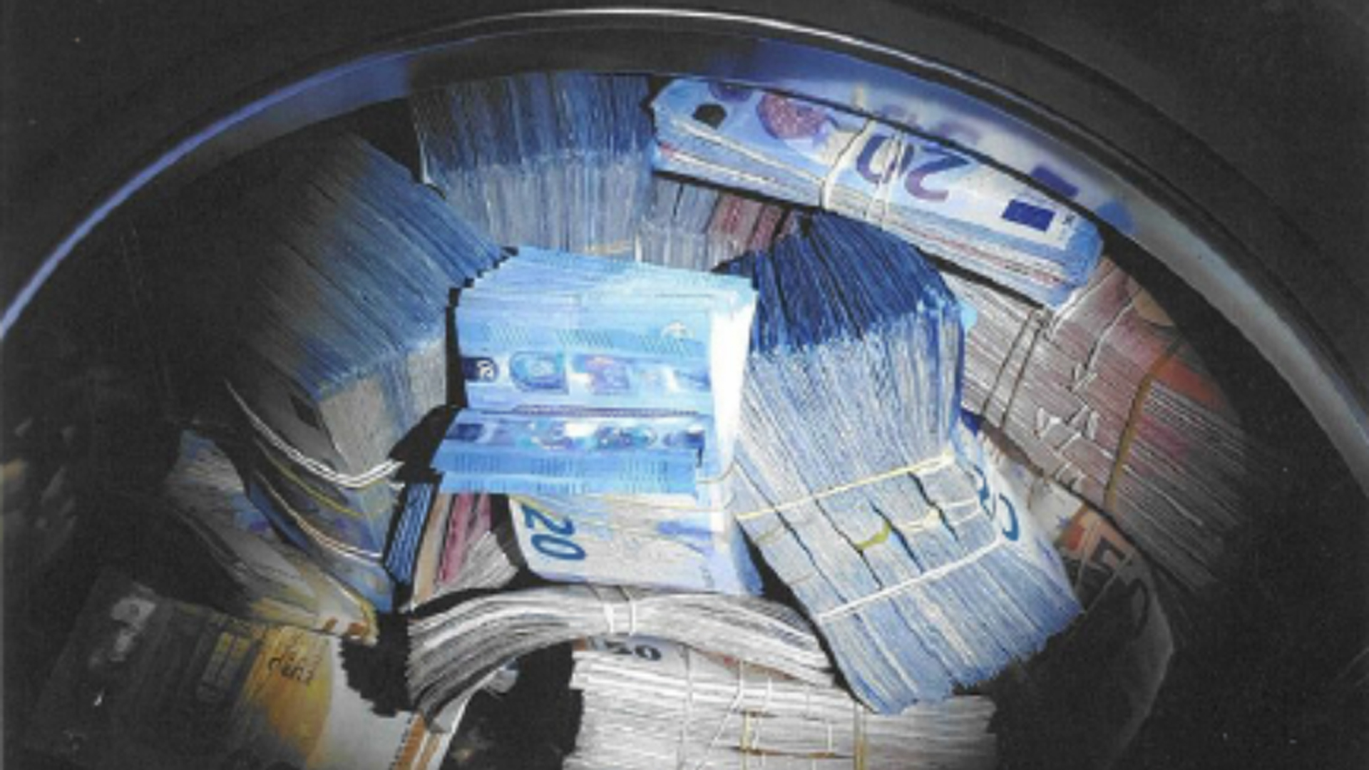 Police in Amsterdam arrested a man on suspicion of money laundering after finding about 350,000 euros, worth about $400,000, in a washing machine. (Credit: Netherlands National Police Corps)