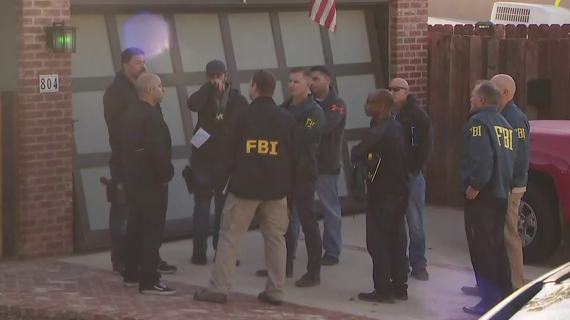 Investigators are seen on Nov. 8, 2018, outside the home of the man suspected of opening fire at a bar in Thousand Oaks the night before, leaving 13 dead including himself. (Credit: KTLA)