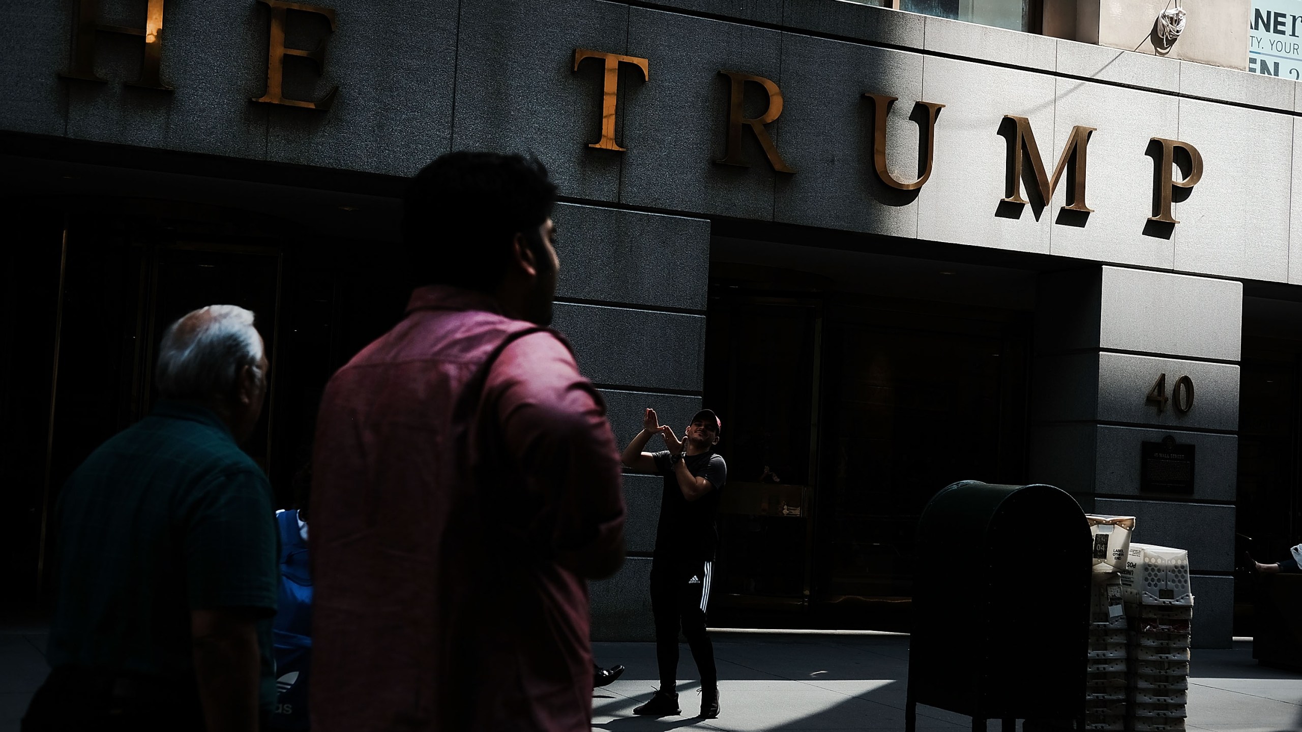 People walk outside of a building owned by President Donald Trump in Manhattan on August 24, 2018 in New York City. (Credit: Spencer Platt/Getty Images)