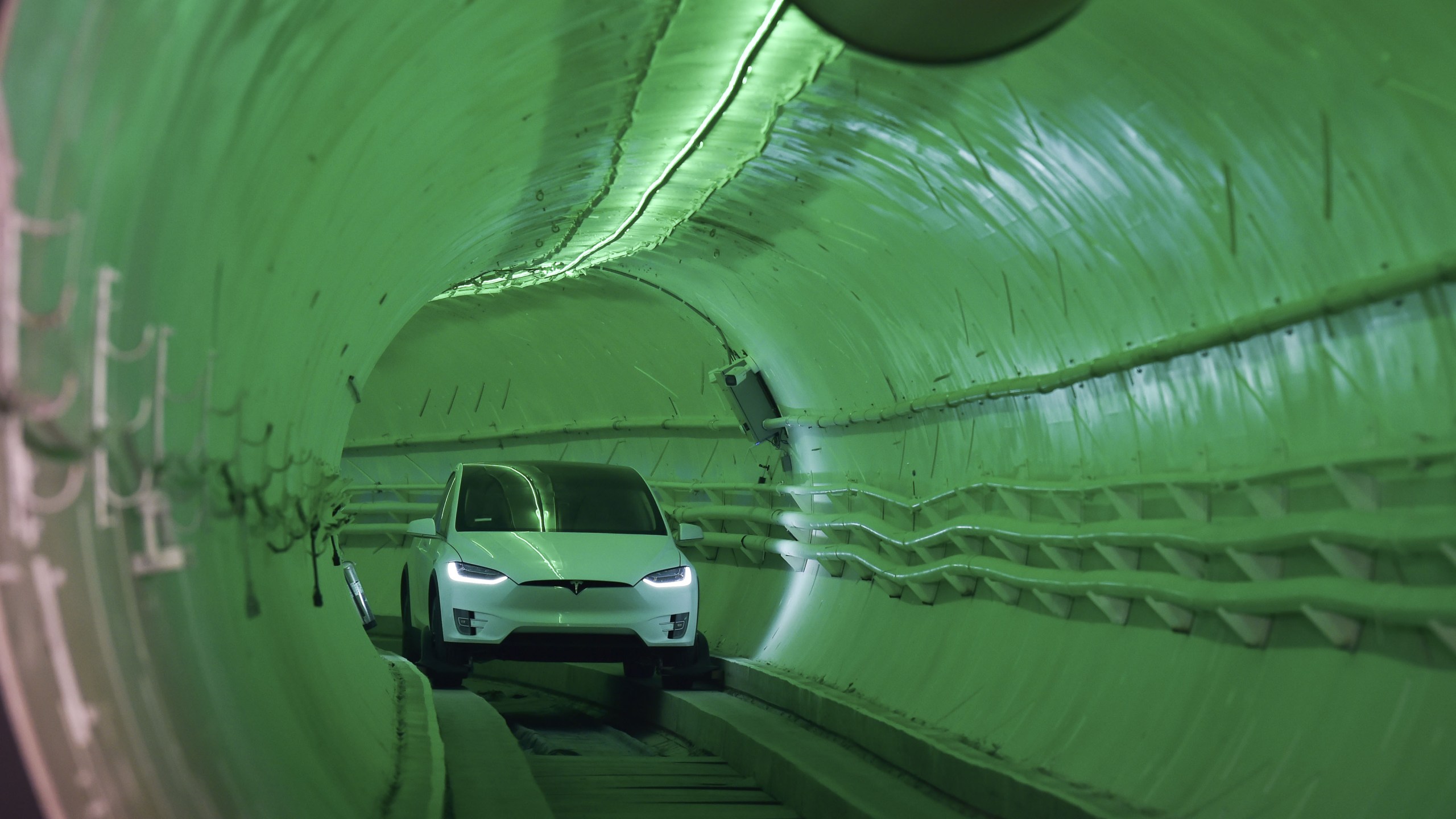 Elon Musk, co-founder and chief executive officer of Tesla, arrives in a modified Tesla Model X electric vehicle during an unveiling event for the Boring Co. test tunnel in Hawthorne on Dec. 18, 2018. (Credit: Robyn Beck / AFP / Getty Images)