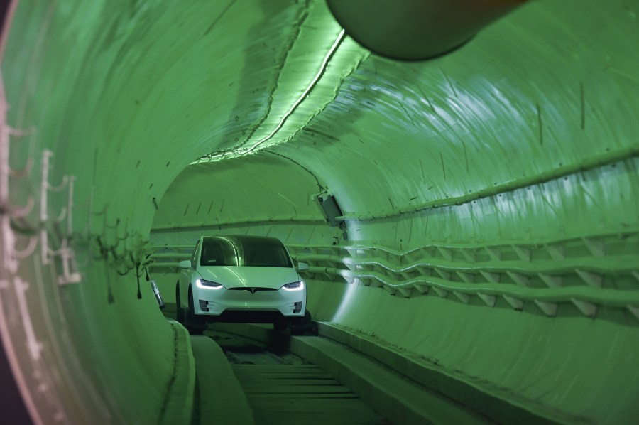 Elon Musk, co-founder and chief executive officer of Tesla, arrives in a modified Tesla Model X electric vehicle during an unveiling event for the Boring Co. test tunnel in Hawthorne on Dec. 18, 2018. (Credit: Robyn Beck / AFP / Getty Images)