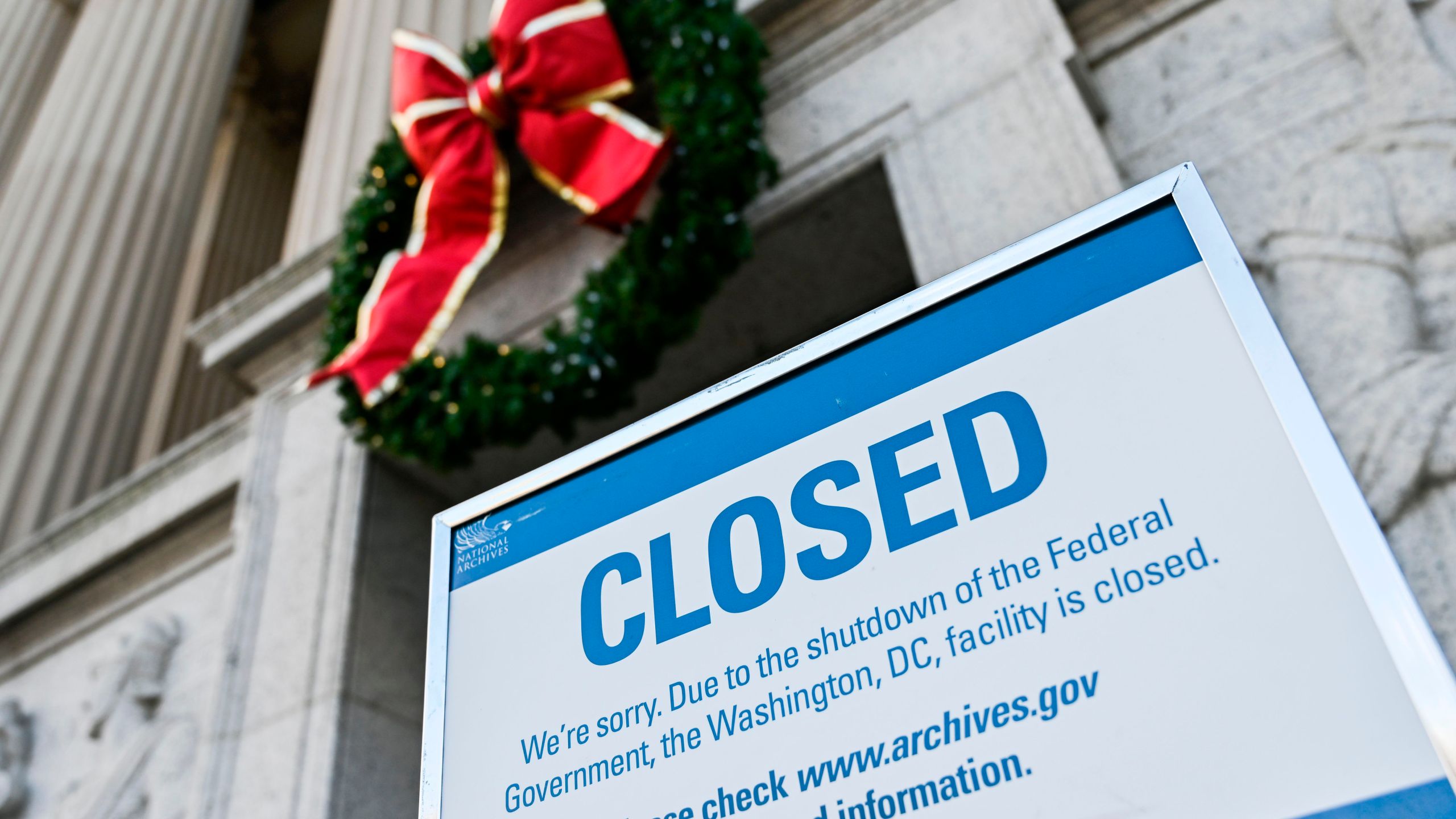 A sign is displayed at the National Archives building that is closed because of a US government shutdown in Washington, DC, on December 22, 2018. - The partial US government shutdown is set to stretch on through Christmas as the Senate adjourned with no deal to end it in sight. (Credit: ANDREW CABALLERO-REYNOLDS/AFP/Getty Images)