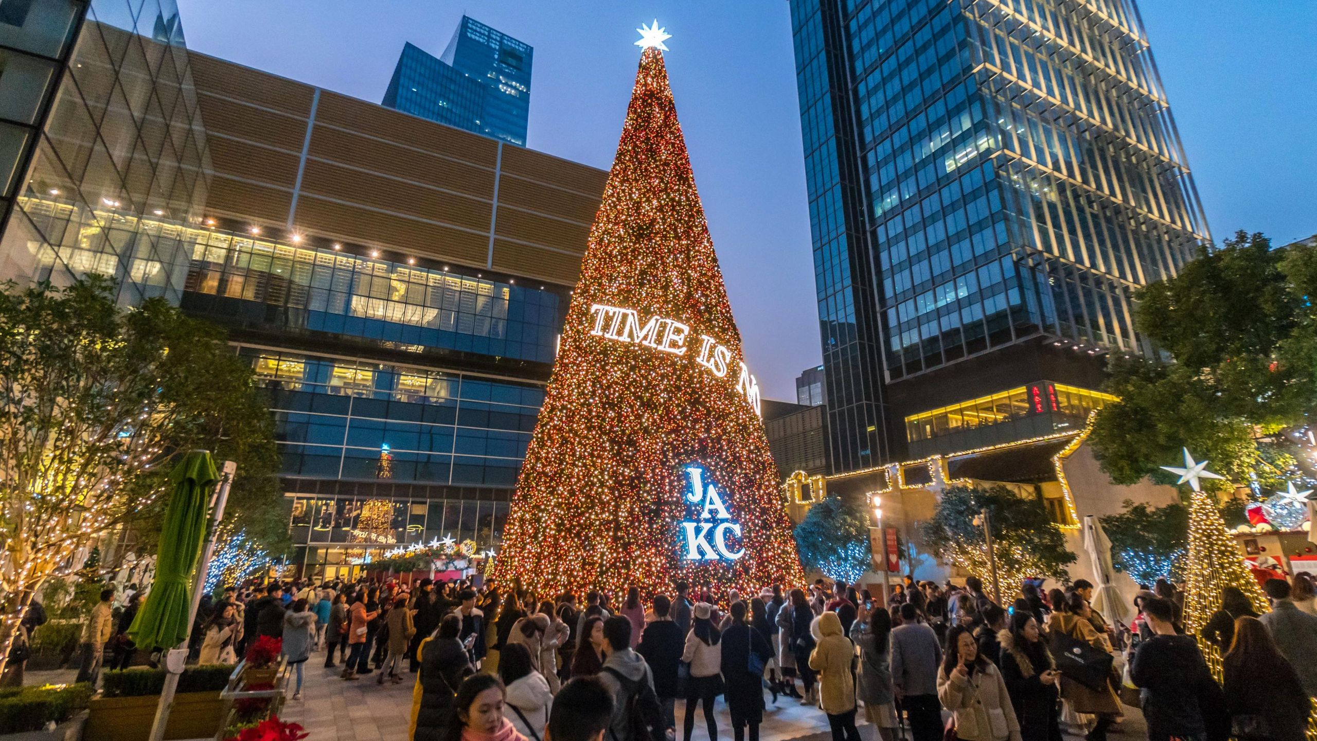 This photo taken on Dec. 23, 2018, shows people gathering around a Christmas tree in Shanghai. (Credit: STR/AFP/Getty Images)