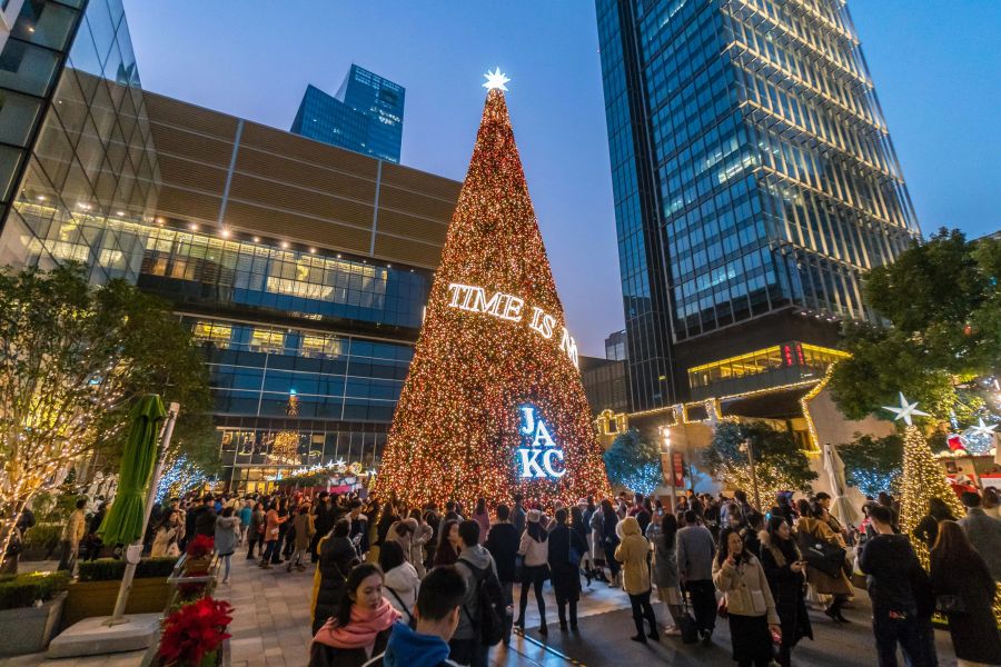 This photo taken on Dec. 23, 2018, shows people gathering around a Christmas tree in Shanghai. (Credit: STR/AFP/Getty Images)