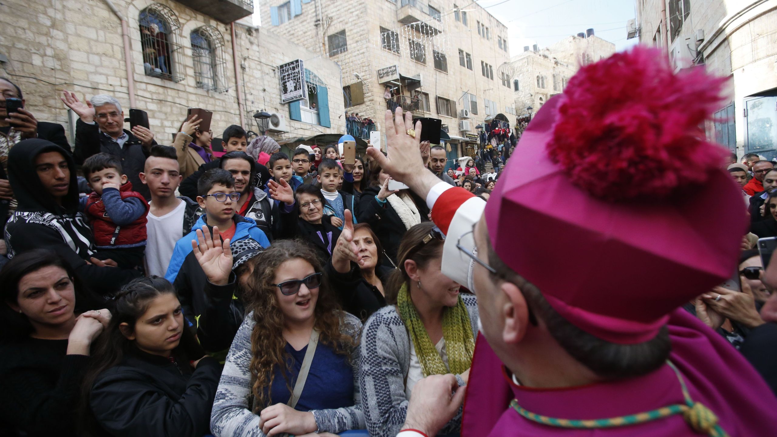 Latin Patriarch of Jerusalem Pierbattista Pizzaballa greets a crowd as he arrives in the West Bank city of Bethlehem, on Dec. 24, 2018. (Credit: HAZEM BADER/AFP/Getty Images)