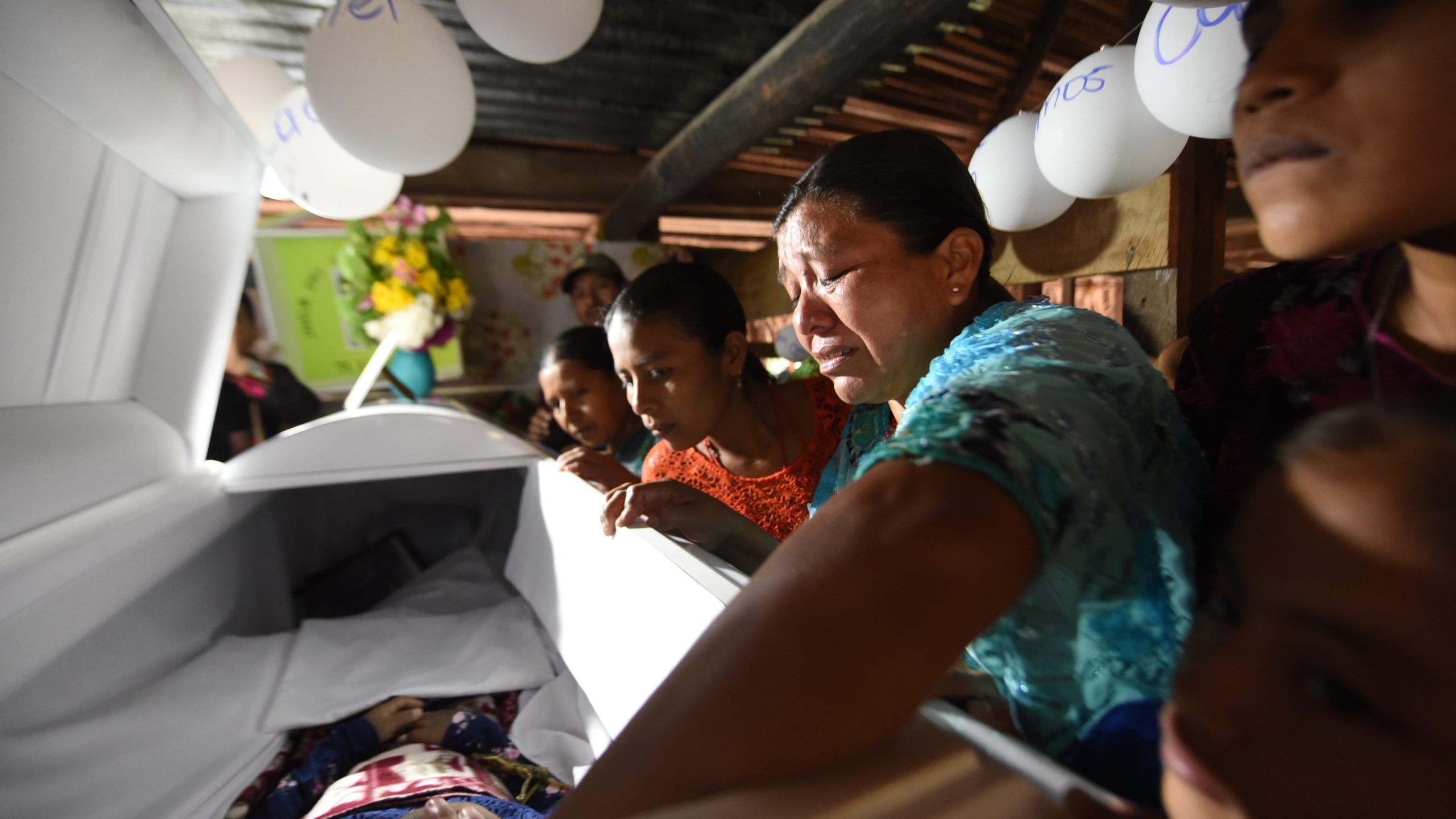 Relatives cry over the coffin of 7-year old Jakelin Caal during a wake in her home village 320 kilometers north of Guatemala City on Dec. 24, 2018. (Credit: JOHAN ORDONEZ/AFP/Getty Images)