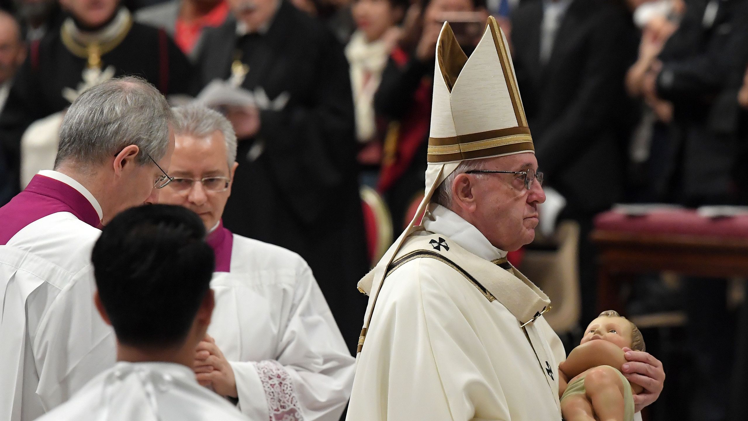 Pope Francis cradles a statue of baby Jesus at end of mass on Christmas eve marking the birth of Jesus Christ on Dec. 24, 2018, at St Peter's Basilica in Vatican. (Credit: TIZIANA FABI/AFP/Getty Images)