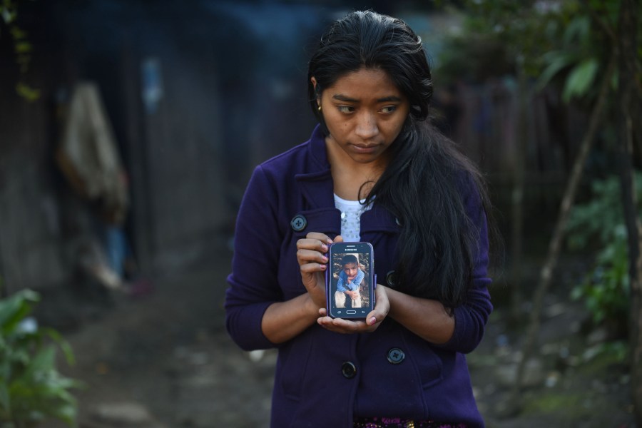 Catarina Gomez Lucas holds up a phone displaying an image of her brother Felipe Gomez in Guatemala on Dec. 28, 2018. (Credit: JOHAN ORDONEZ/AFP/Getty Images)