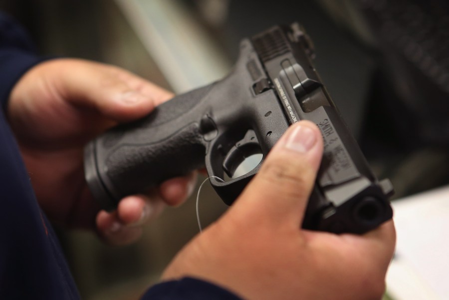 A person holds a pistol in this file photo. (Credit: Scott Olson/Getty Images)