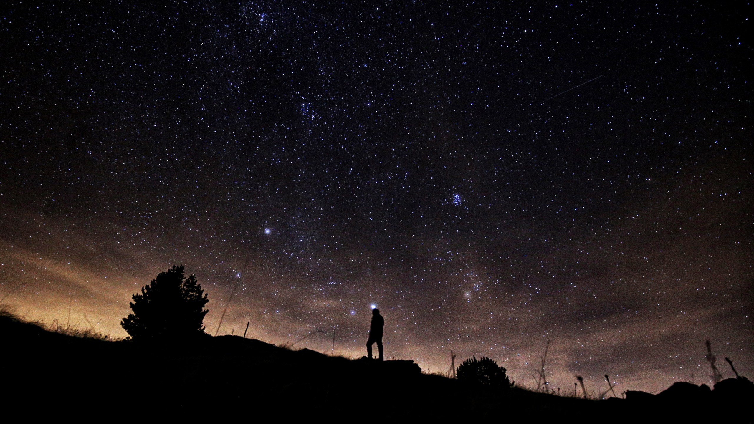 A photographer prepares to take pictures of the annual Geminid meteor shower on the Elva Hill, in Maira Valley, near Cuneo, northern Italy on December 12, 2015. (Credit: MARCO BERTORELLO/AFP/Getty Images)