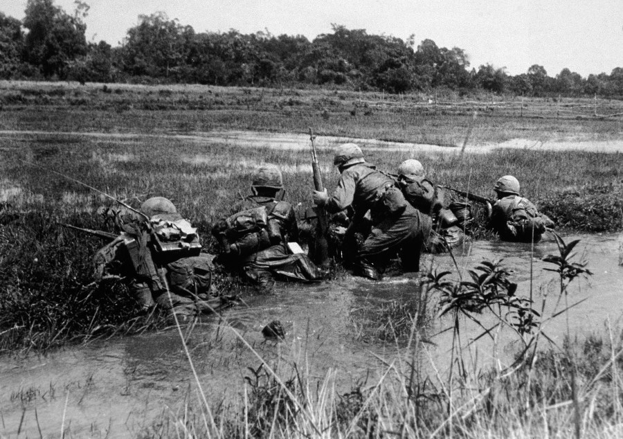 American army combat platoon leader Second Lieutenant John Libs (center) of 2nd platoon, C Company, 2d Battalion, 16th Infantry Regiment, 1st Division, surveys the situation in Vietnam, mid 1960s. (Credit: Hulton Archive/Getty Images)