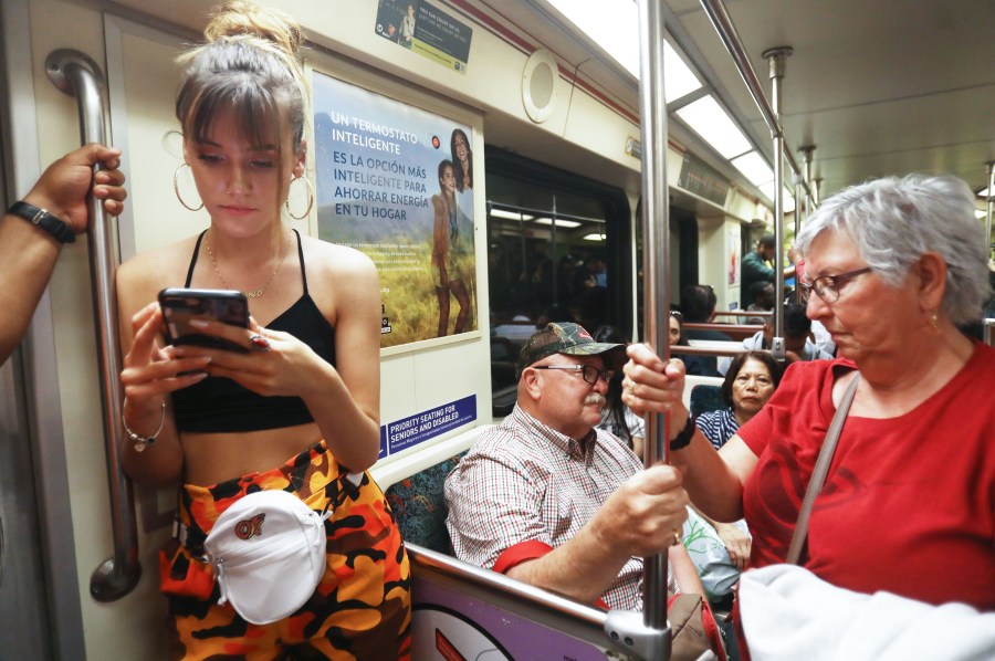 People ride an L.A. County Metro train on March 28, 2018. (Credit: Mario Tama / Getty Images)